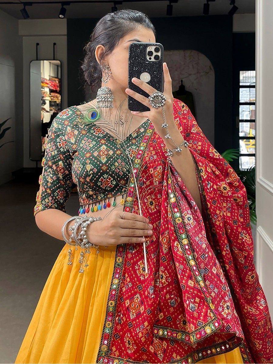 Woman in vibrant Indian lehenga choli with peacock embroidery, mirror work, and colorful dupatta, perfect for festive occasions.