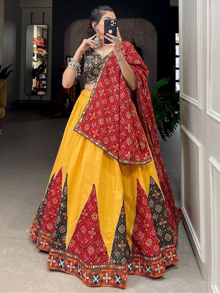 Vibrant yellow and red embroidered lehenga choli with mirror work, perfect for Indian weddings and festive occasions.