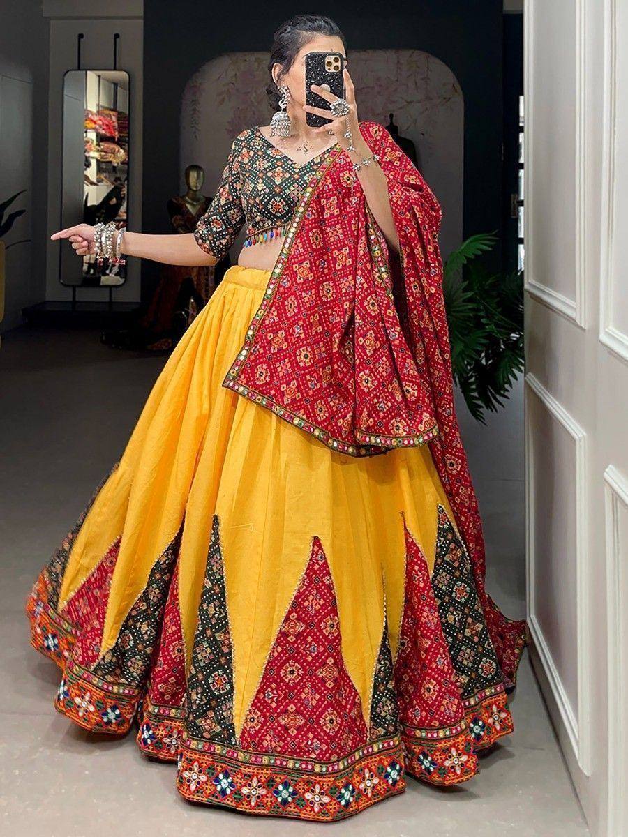 Vibrant yellow and red embroidered lehenga choli with mirror work, perfect for Indian ethnic occasions