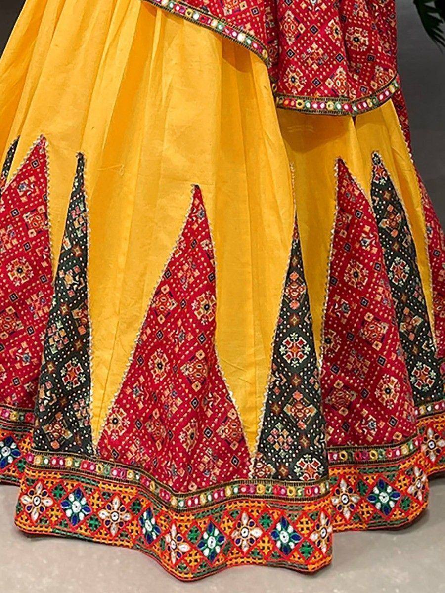 Yellow and red embroidered lehenga choli with mirror work and geometric patterns