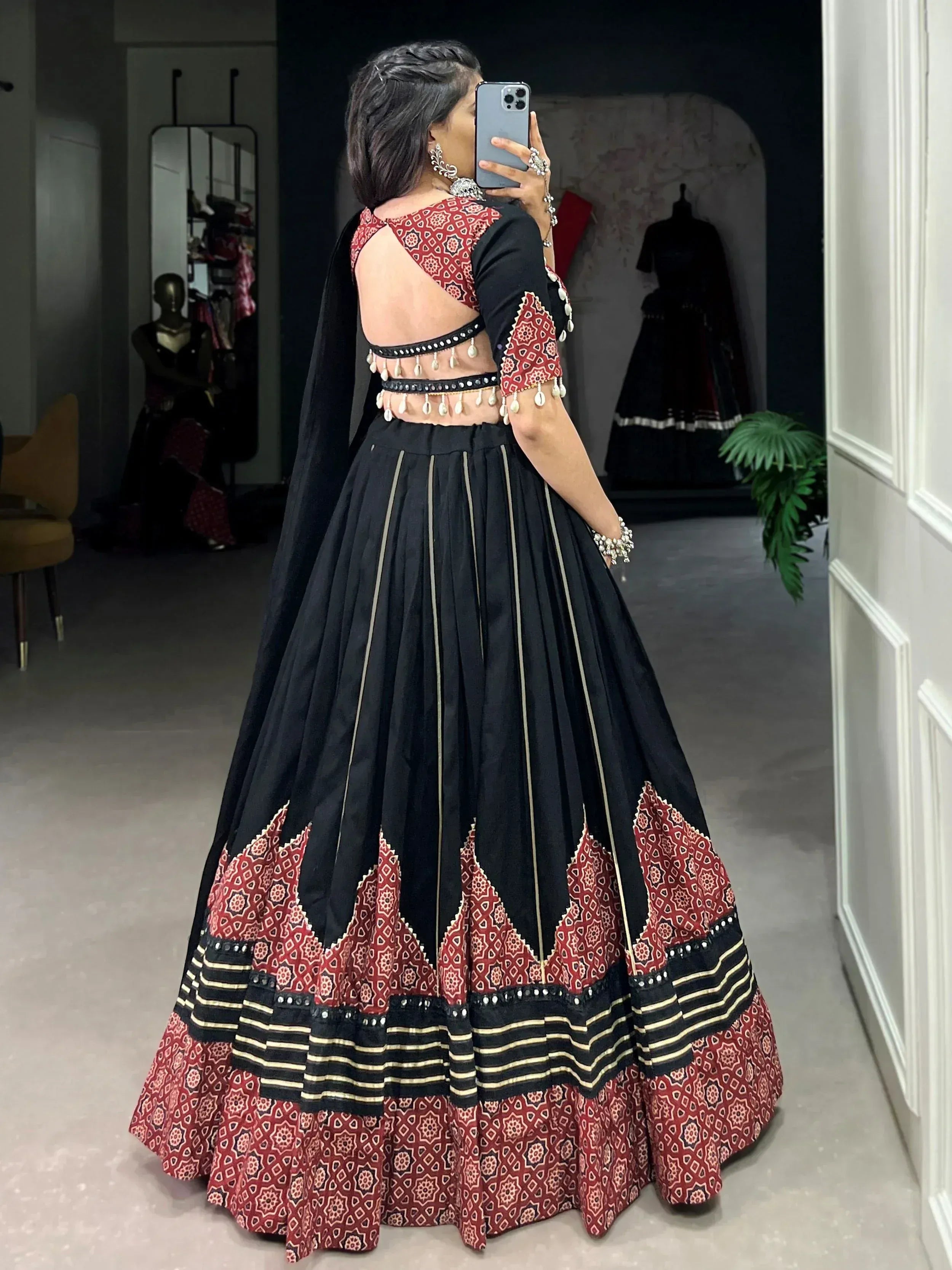 Black and red ethnic lehenga choli with mirror work and geometric print, back view