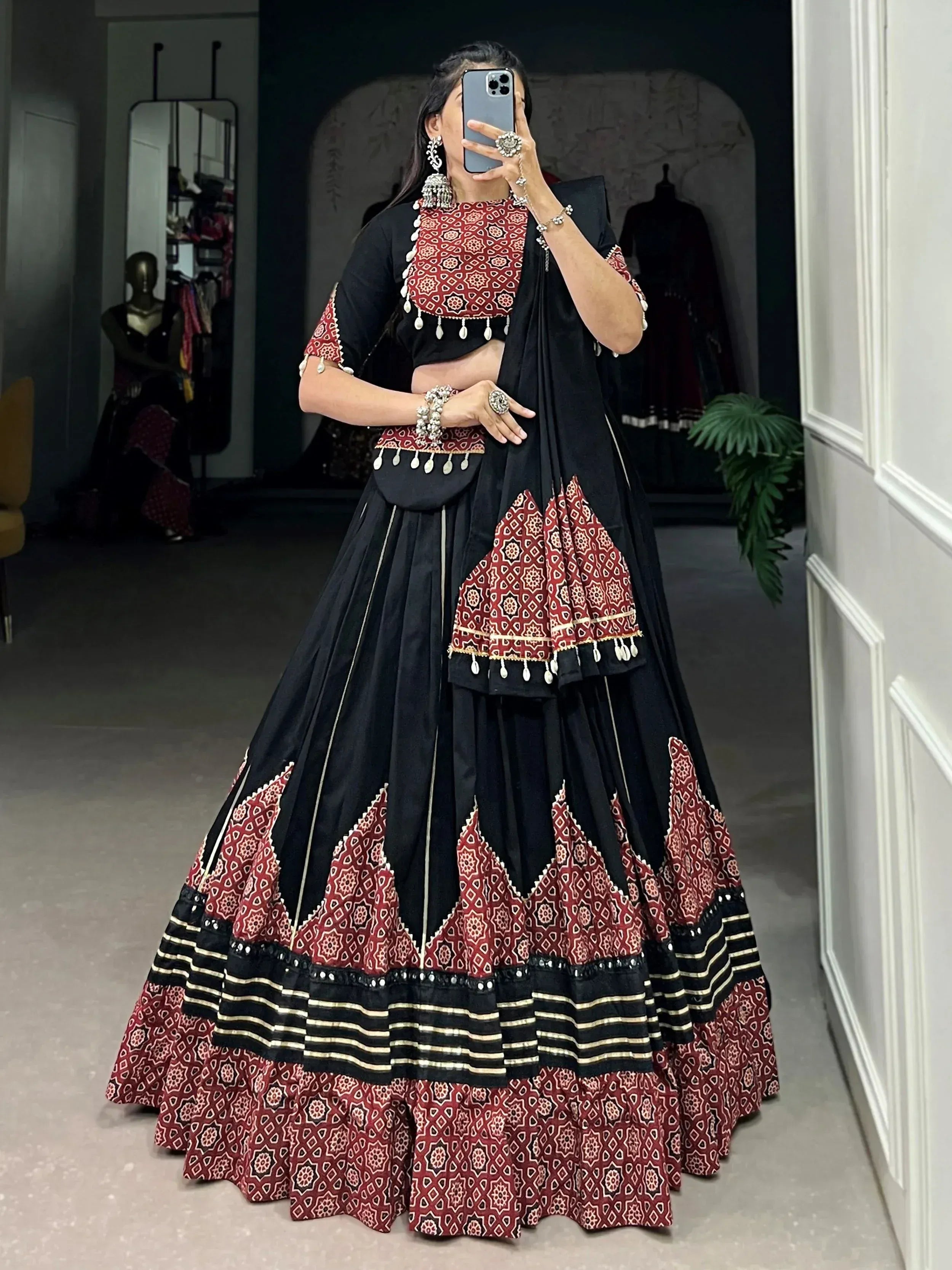 Black and red printed lehenga choli with mirror work, perfect for Indian ethnic wear and festive occasions.