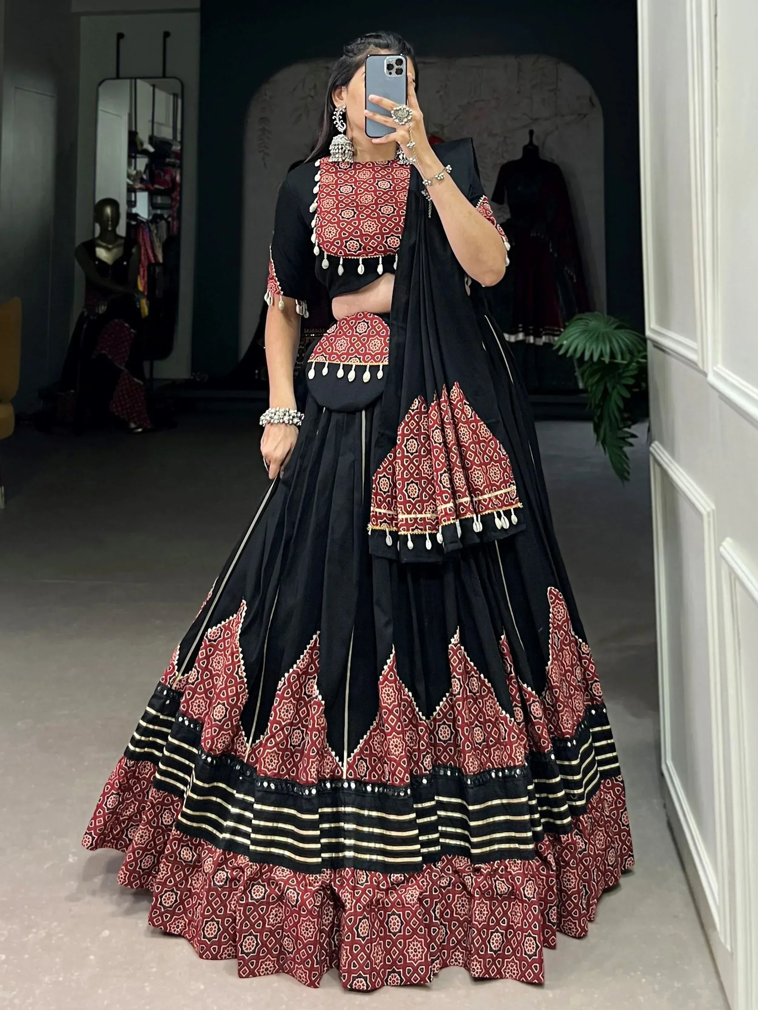 Black and red printed lehenga choli with mirror work, perfect for Indian ethnic wear and festive occasions.