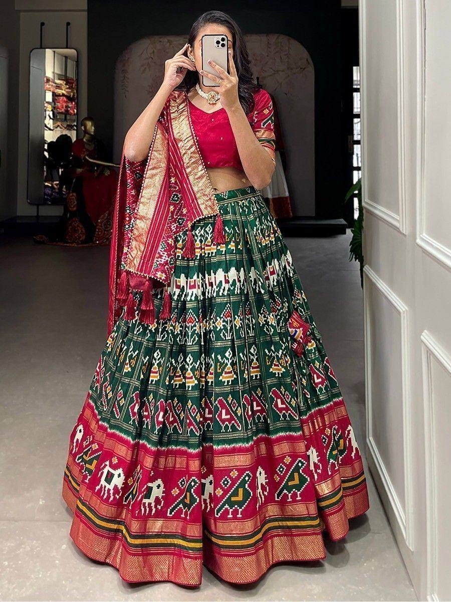 Green and red printed lehenga choli with ethnic motifs, perfect for Indian weddings and festivals