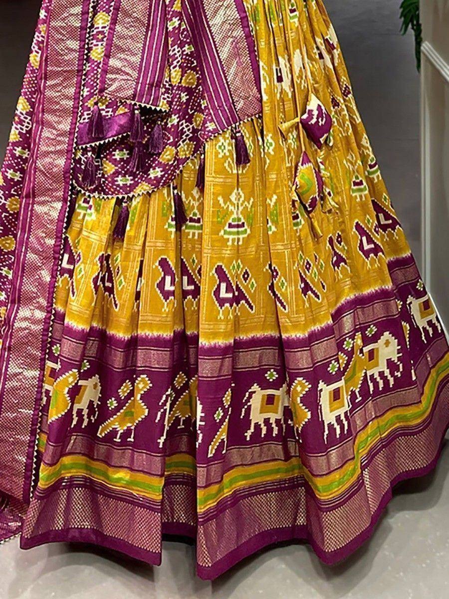Yellow and purple Ikat lehenga with elephant motifs, tassels, and traditional Indian ethnic print design