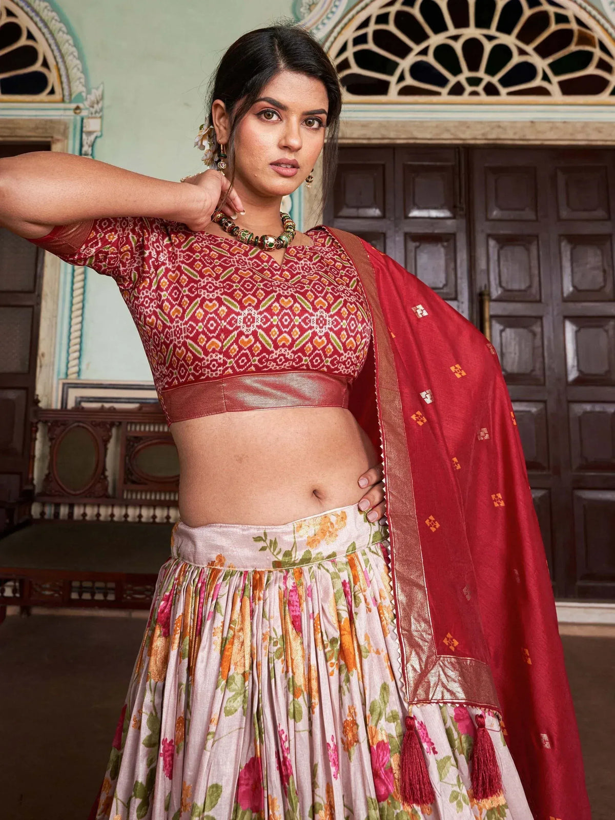 Woman in red printed lehenga choli with floral skirt and dupatta, ethnic Indian wear