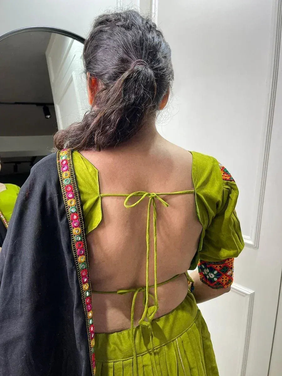 Green ethnic backless top with tie-up detail and colorful embroidery, paired with black dupatta