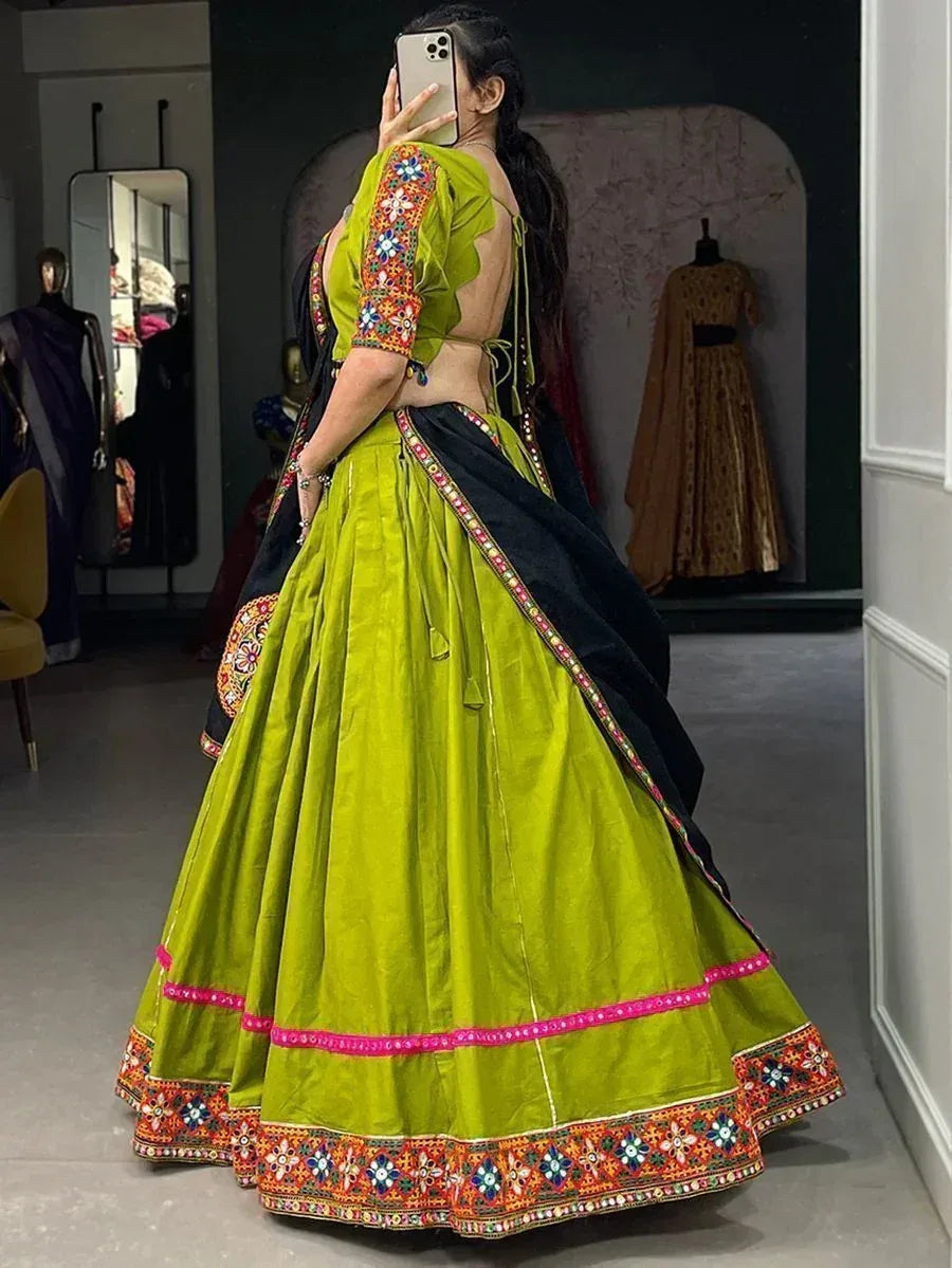 Vibrant green lehenga choli with colorful embroidery and mirror work, perfect for Indian ethnic occasions.