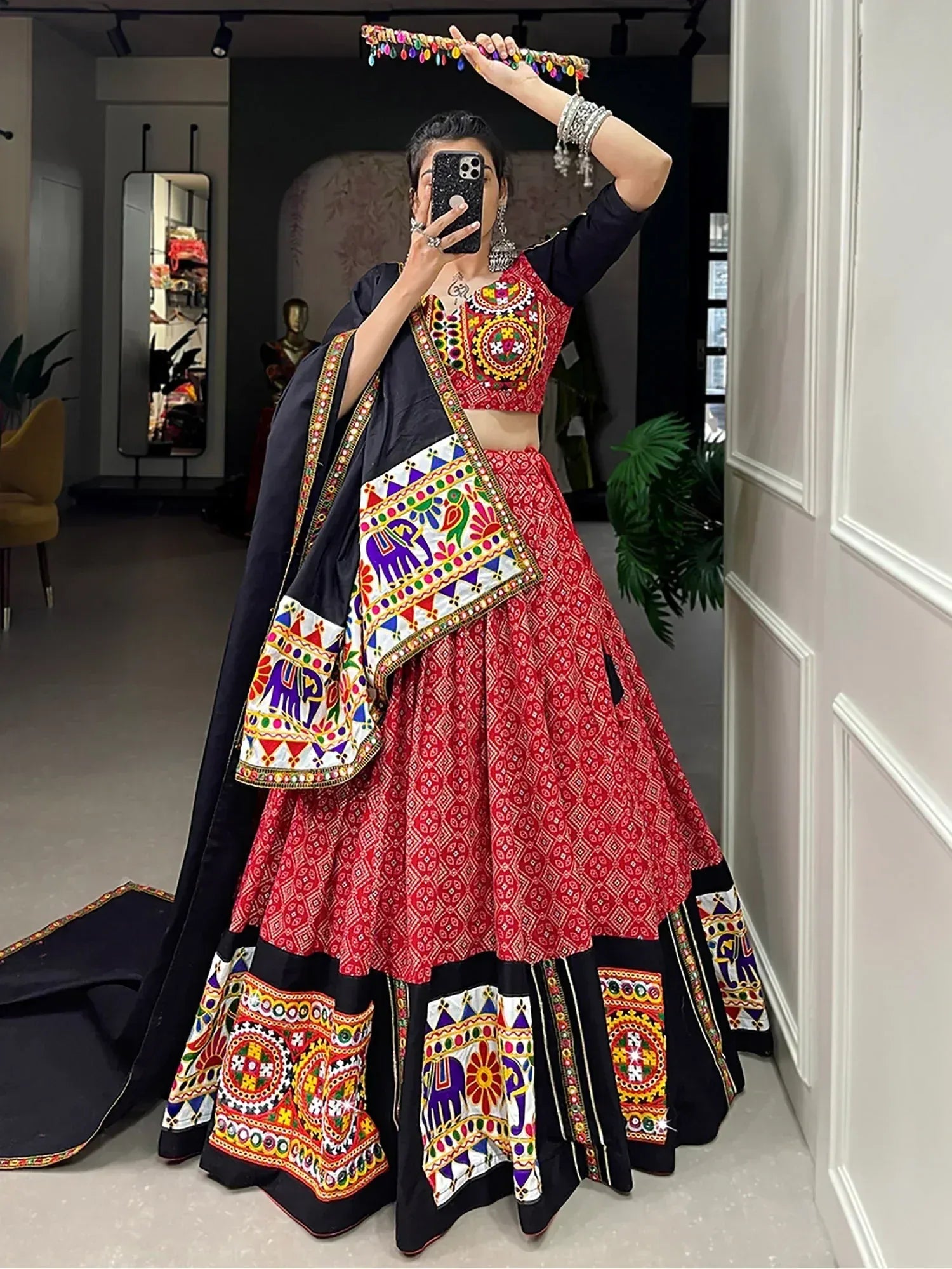 Vibrant red and black embroidered lehenga choli with colorful mirror work and elephant motifs, perfect for Indian ethnic wear.