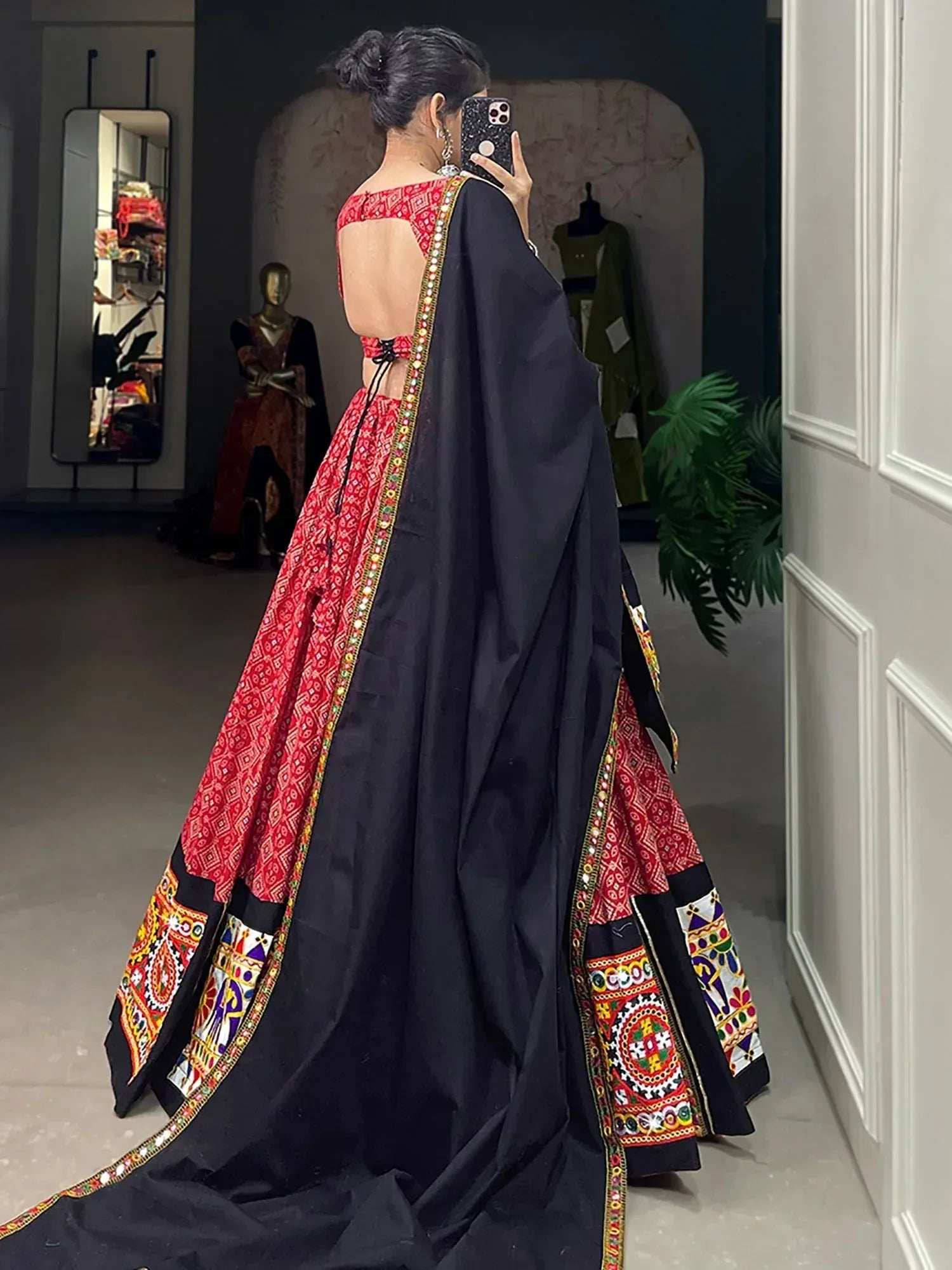 Red and black embroidered lehenga choli with mirror work, backless blouse, and dupatta for Indian ethnic wear
