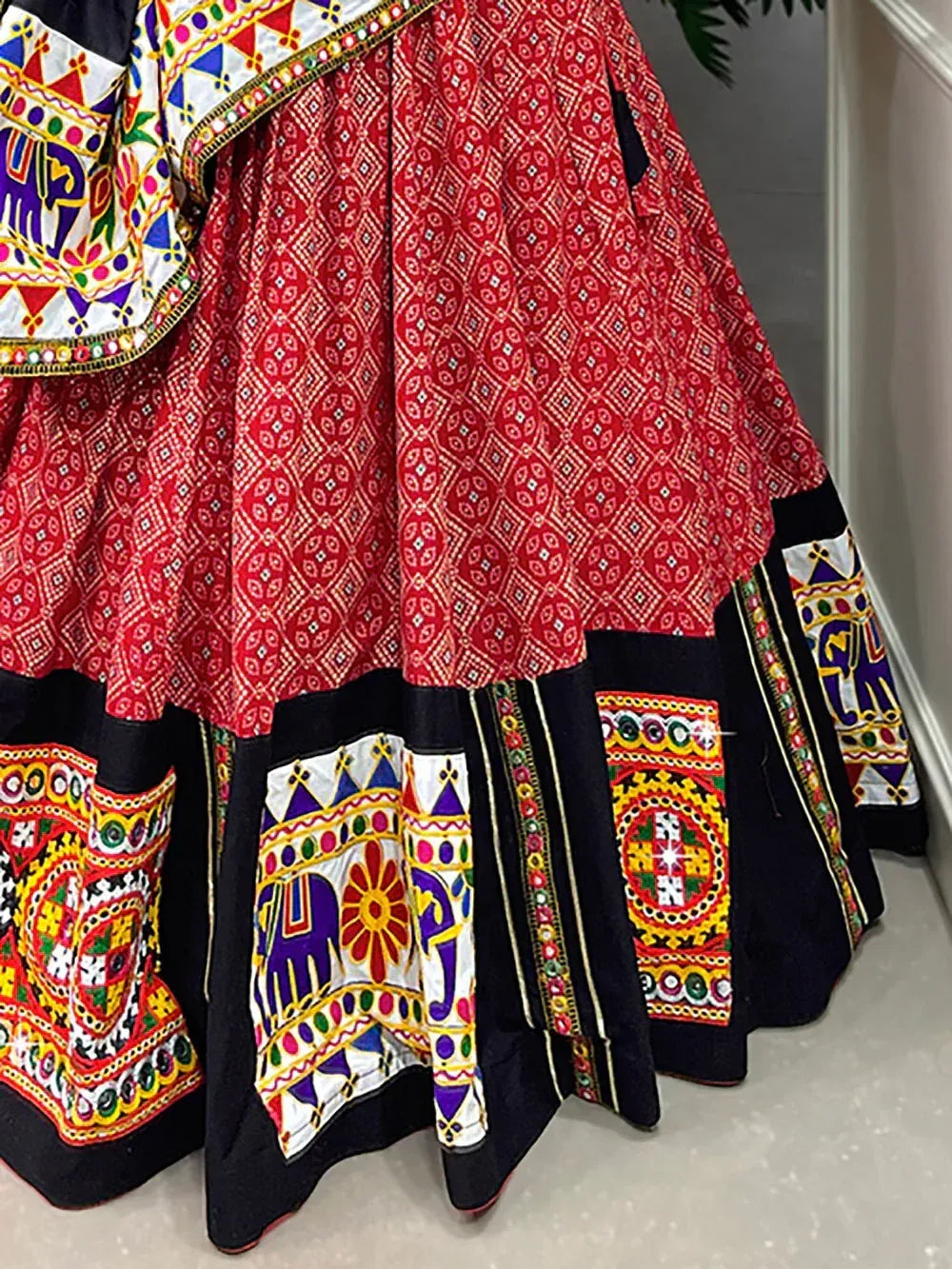 Red and black ethnic lehenga with colorful elephant embroidery and geometric patterns