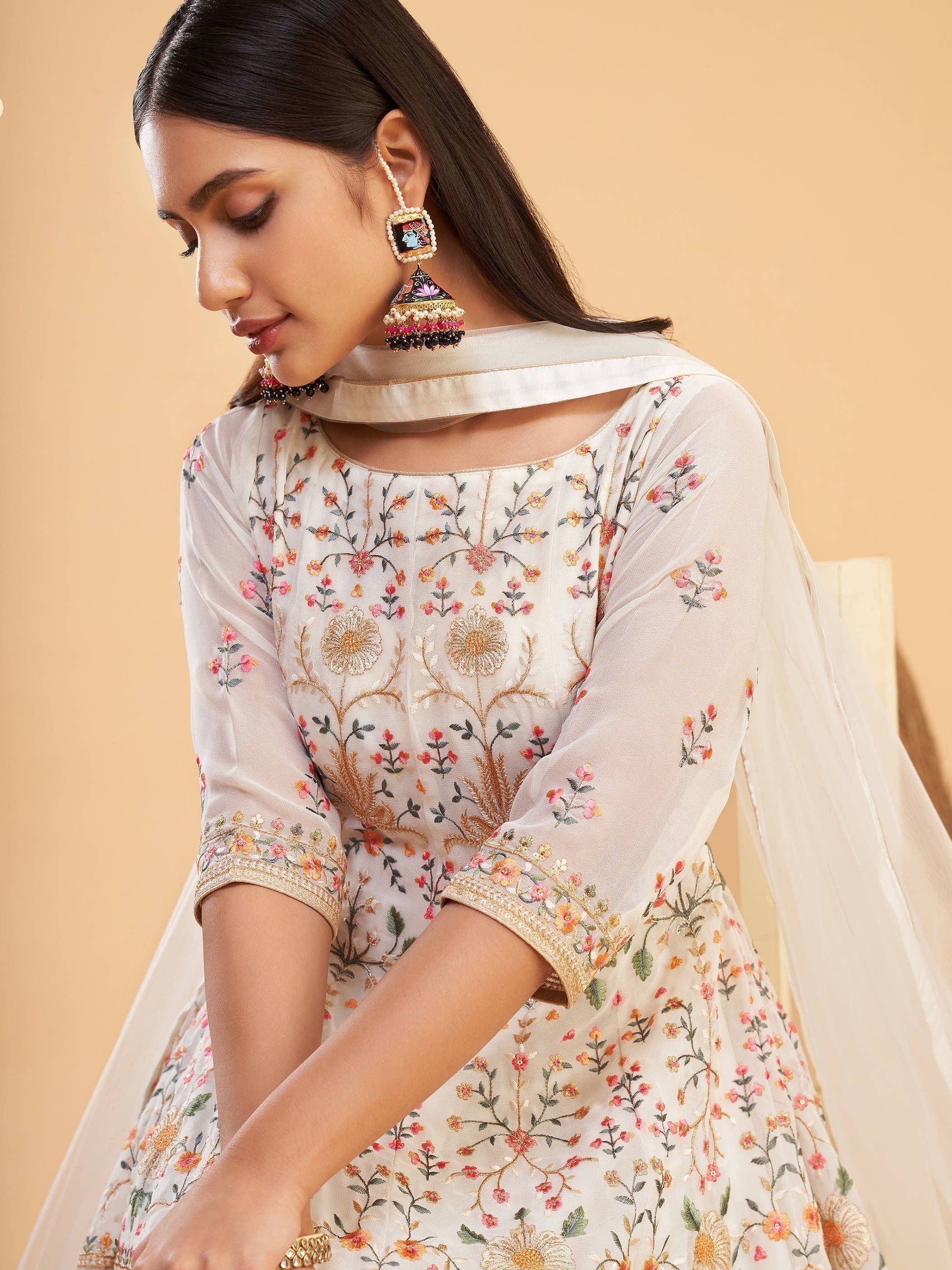 Elegant white floral embroidered ethnic gown with matching dupatta and statement earrings