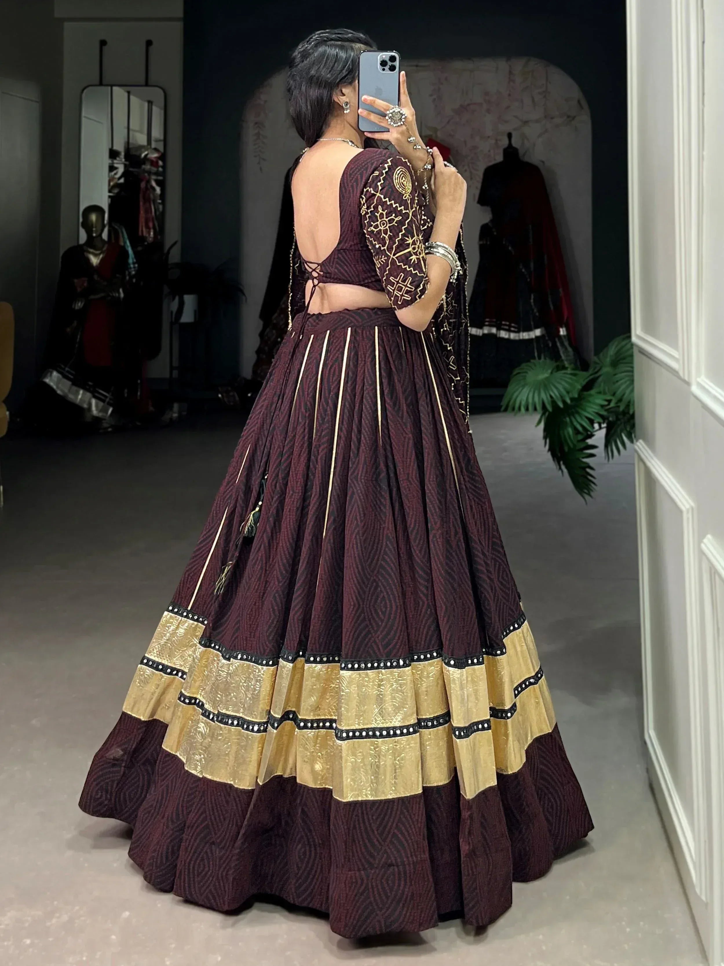 Maroon and gold designer lehenga choli with backless blouse and embroidered skirt, perfect for Indian ethnic wear