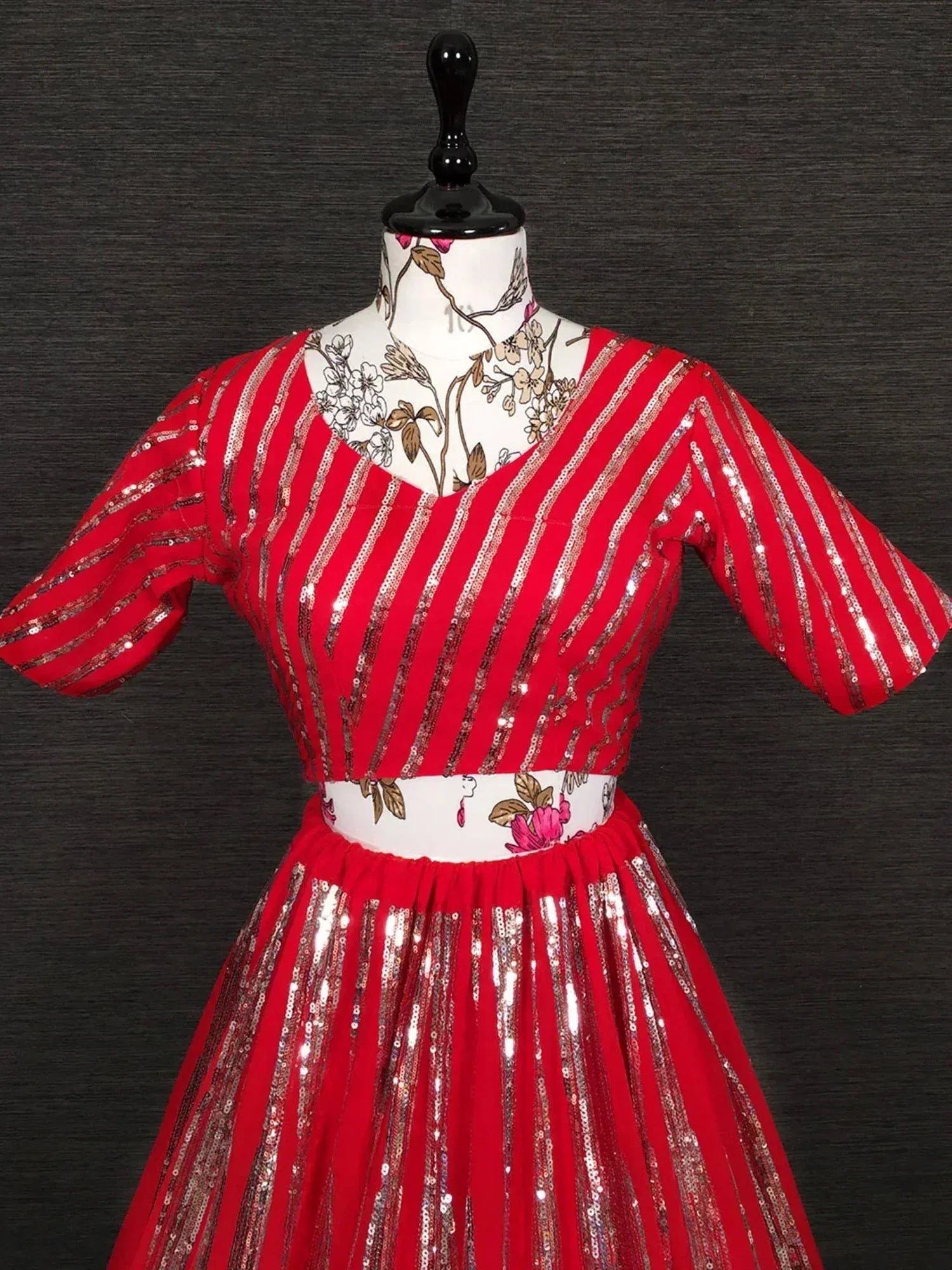 Red sequin stripe ethnic gown with floral waistband, perfect for Indian celebrations and parties