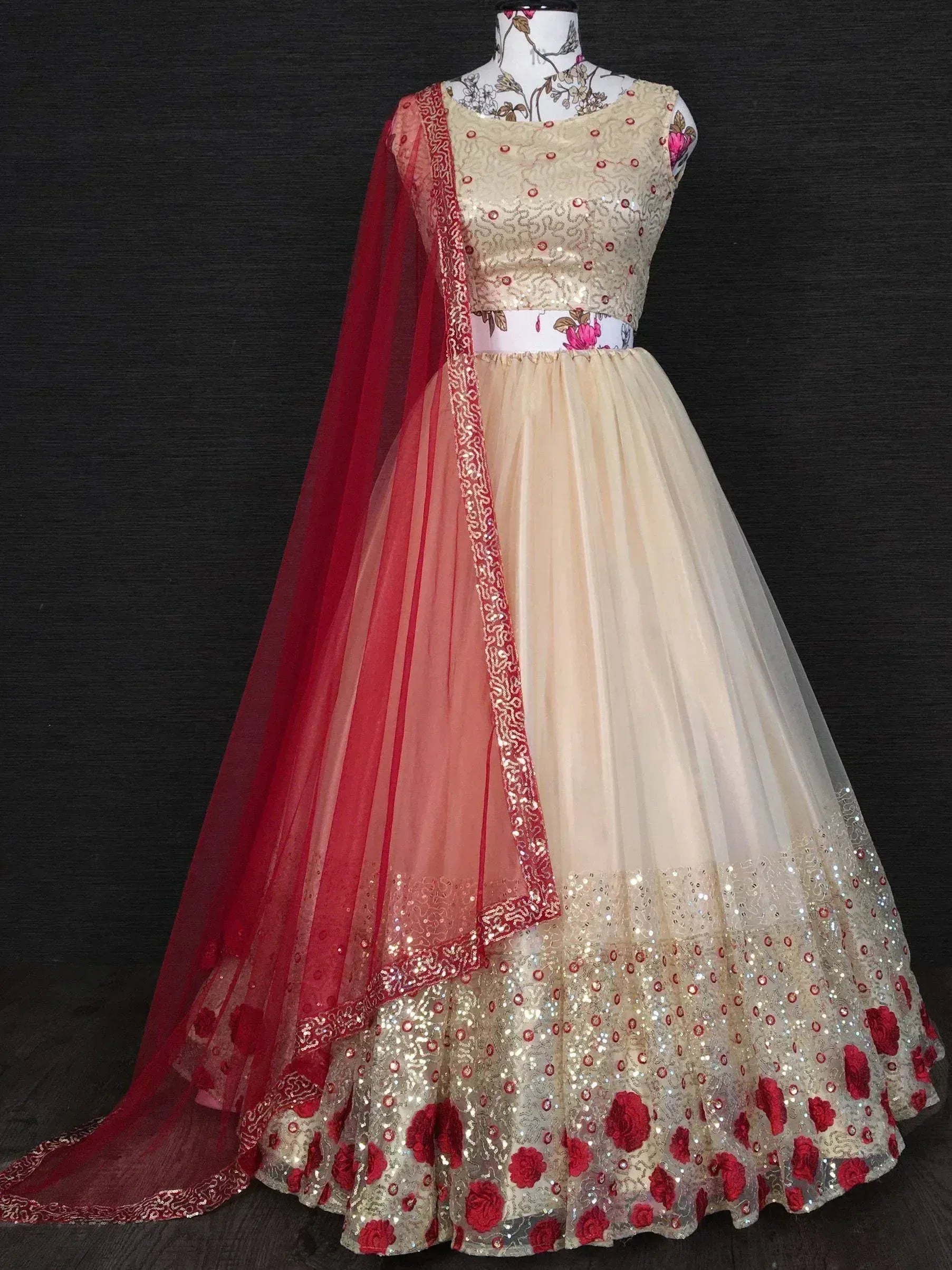 Beige and red designer lehenga choli with floral embroidery and sequins, perfect for Indian ethnic wear occasions.