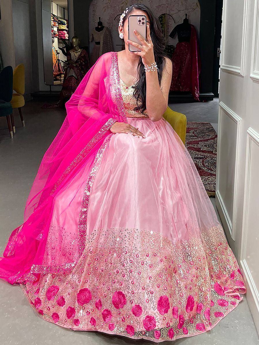 Pink embroidered lehenga choli with floral detailing and matching dupatta, perfect for Indian weddings or festive occasions.