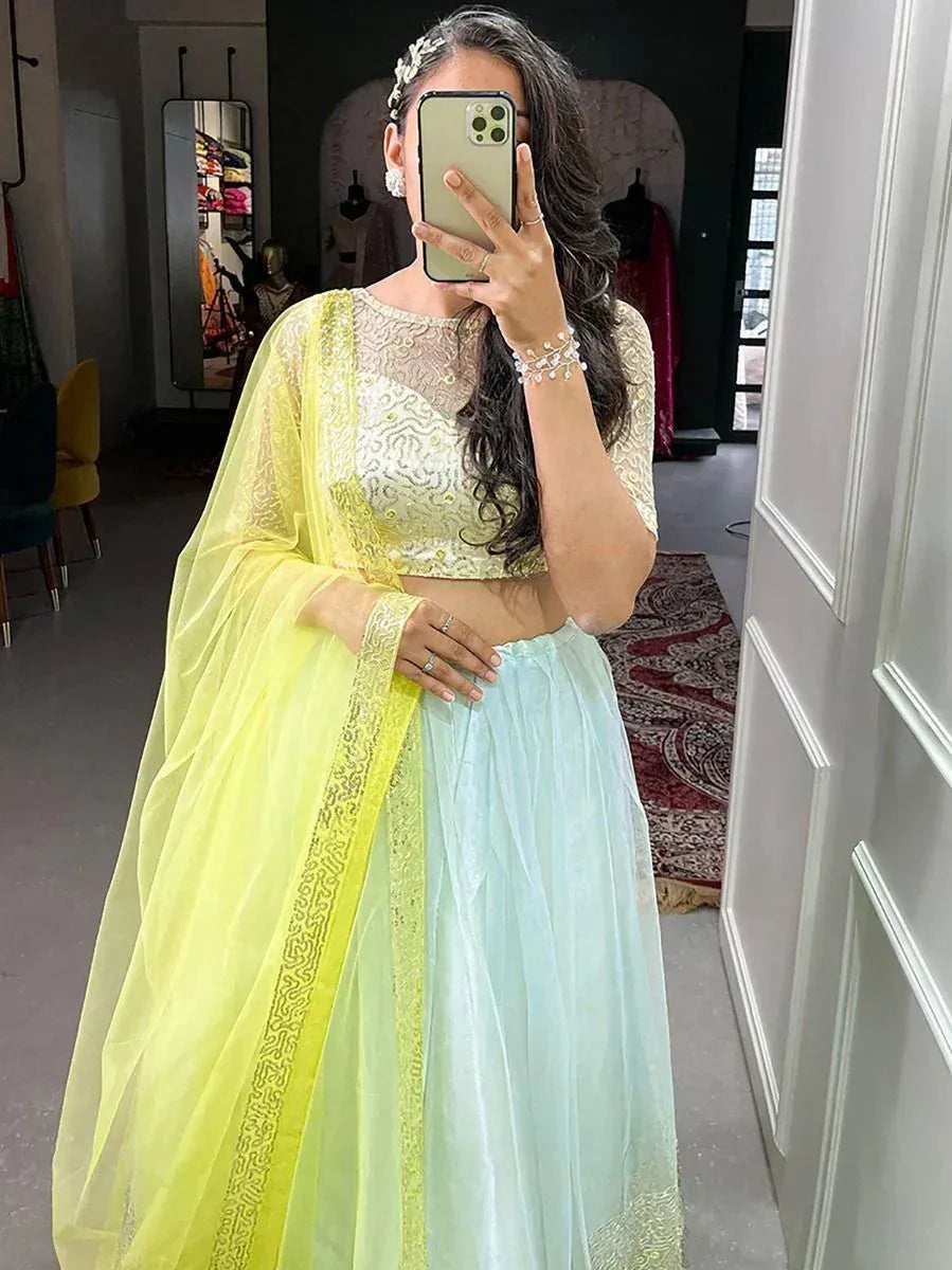 Woman in pastel lehenga choli with yellow dupatta, ethnic wear for weddings or parties