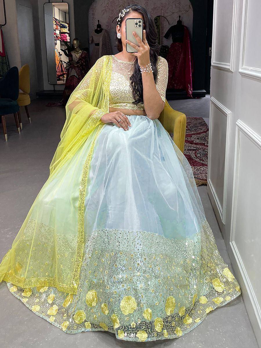 Yellow and mint green designer lehenga choli with floral embroidery, perfect for Indian weddings and festive occasions.