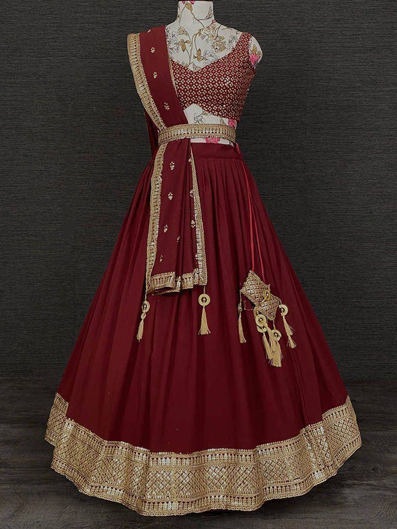Maroon designer lehenga choli with gold embroidery and tassels, ethnic Indian wear