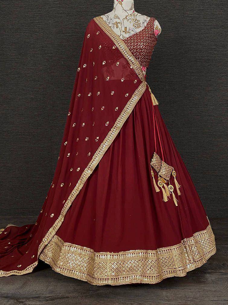 Maroon designer lehenga choli with gold embroidery and dupatta, perfect for Indian weddings and festive occasions.