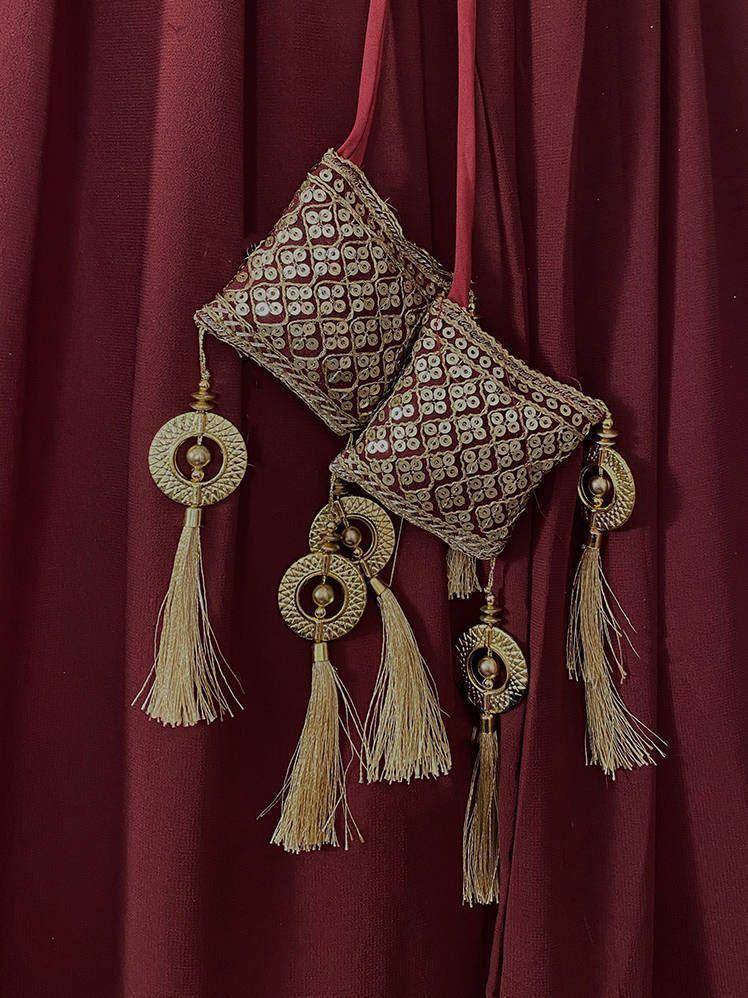 Maroon ethnic potli bag with gold mirror work and tassels, perfect for Indian weddings and festive occasions