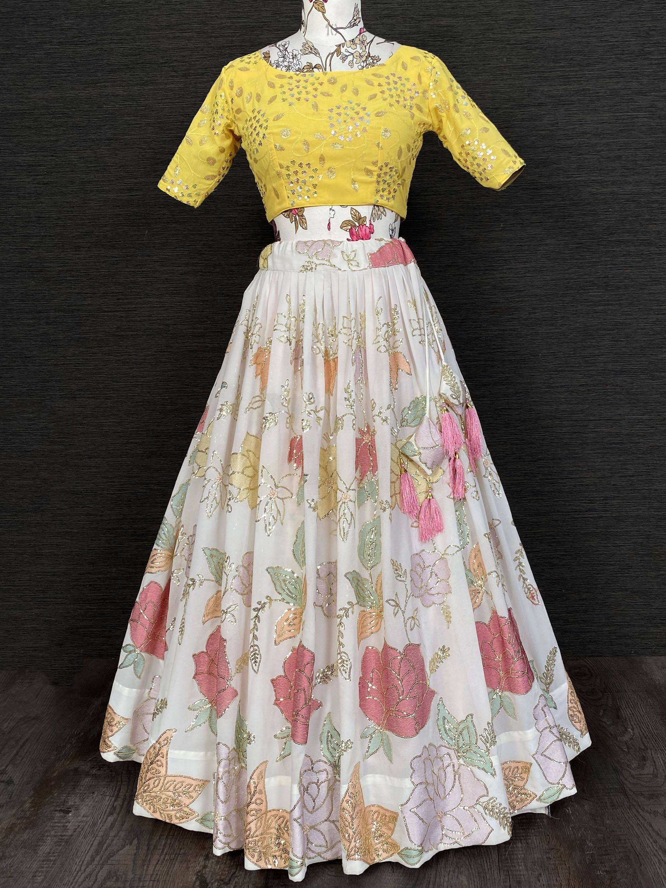 Yellow embroidered crop top with floral white lehenga, perfect for Indian ethnic wear events