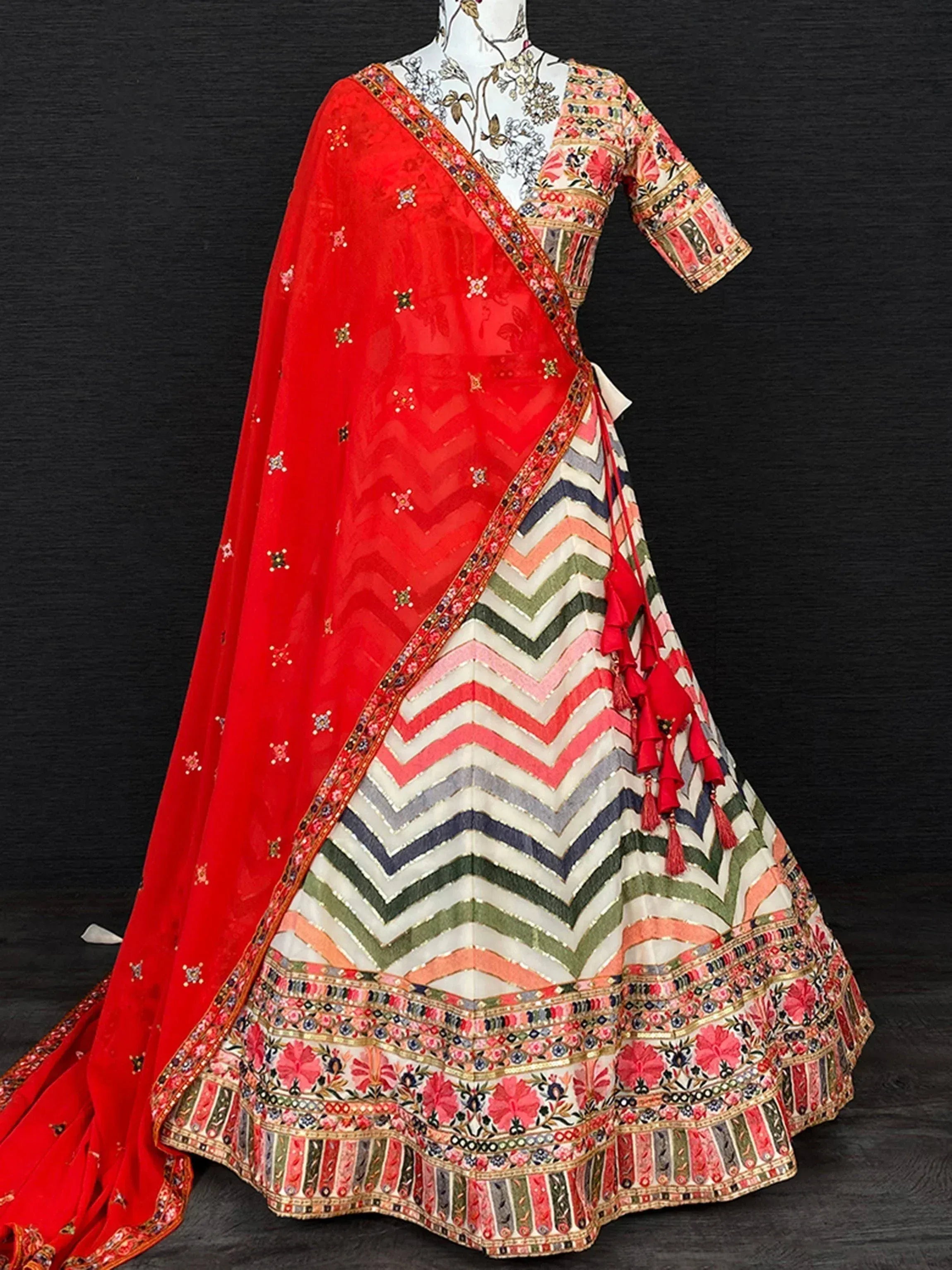 Colorful Indian lehenga choli with chevron skirt, floral blouse, and red dupatta for ethnic wear