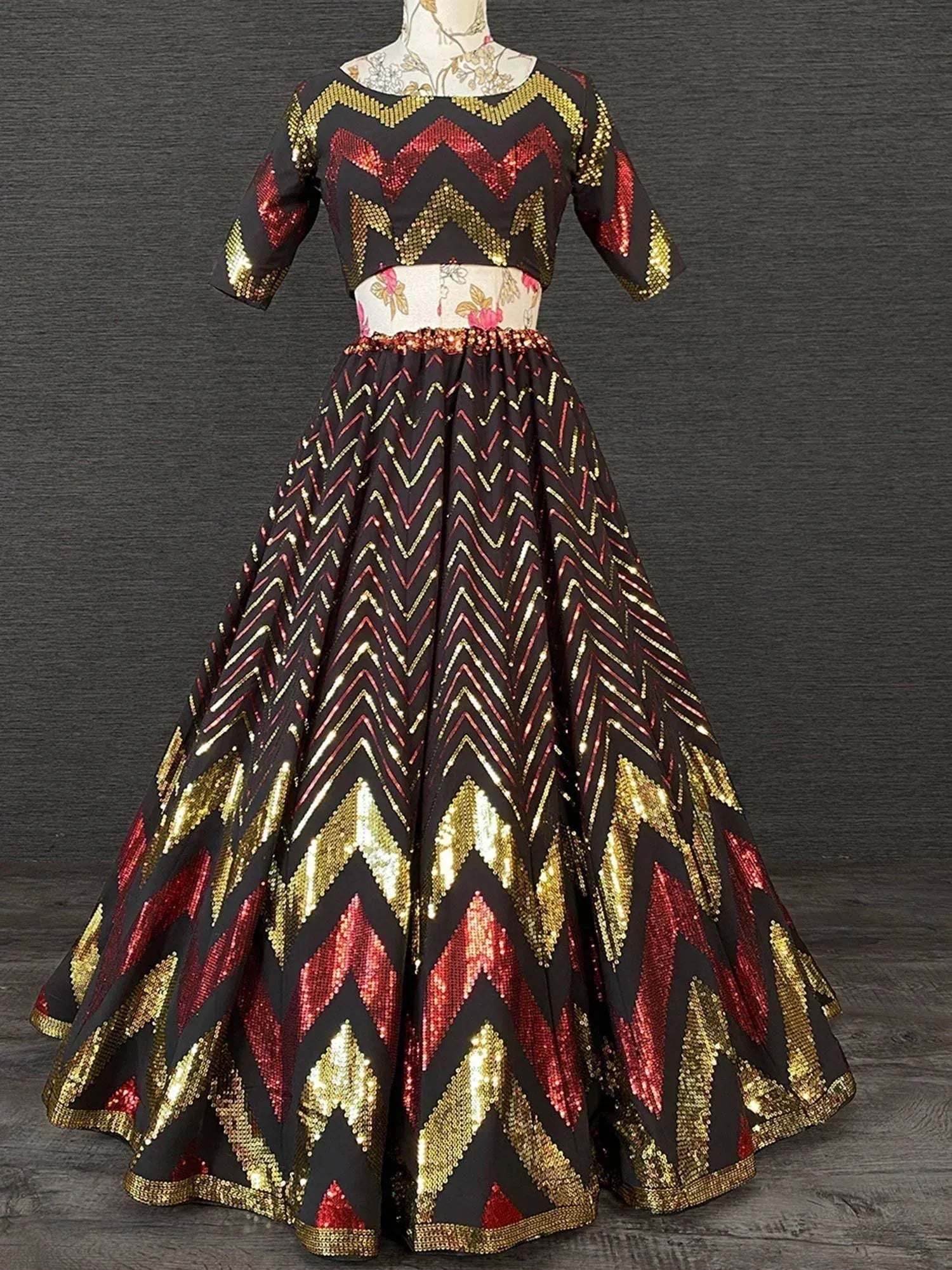 Black lehenga choli with gold and red chevron sequin design, perfect for Indian ethnic wear events