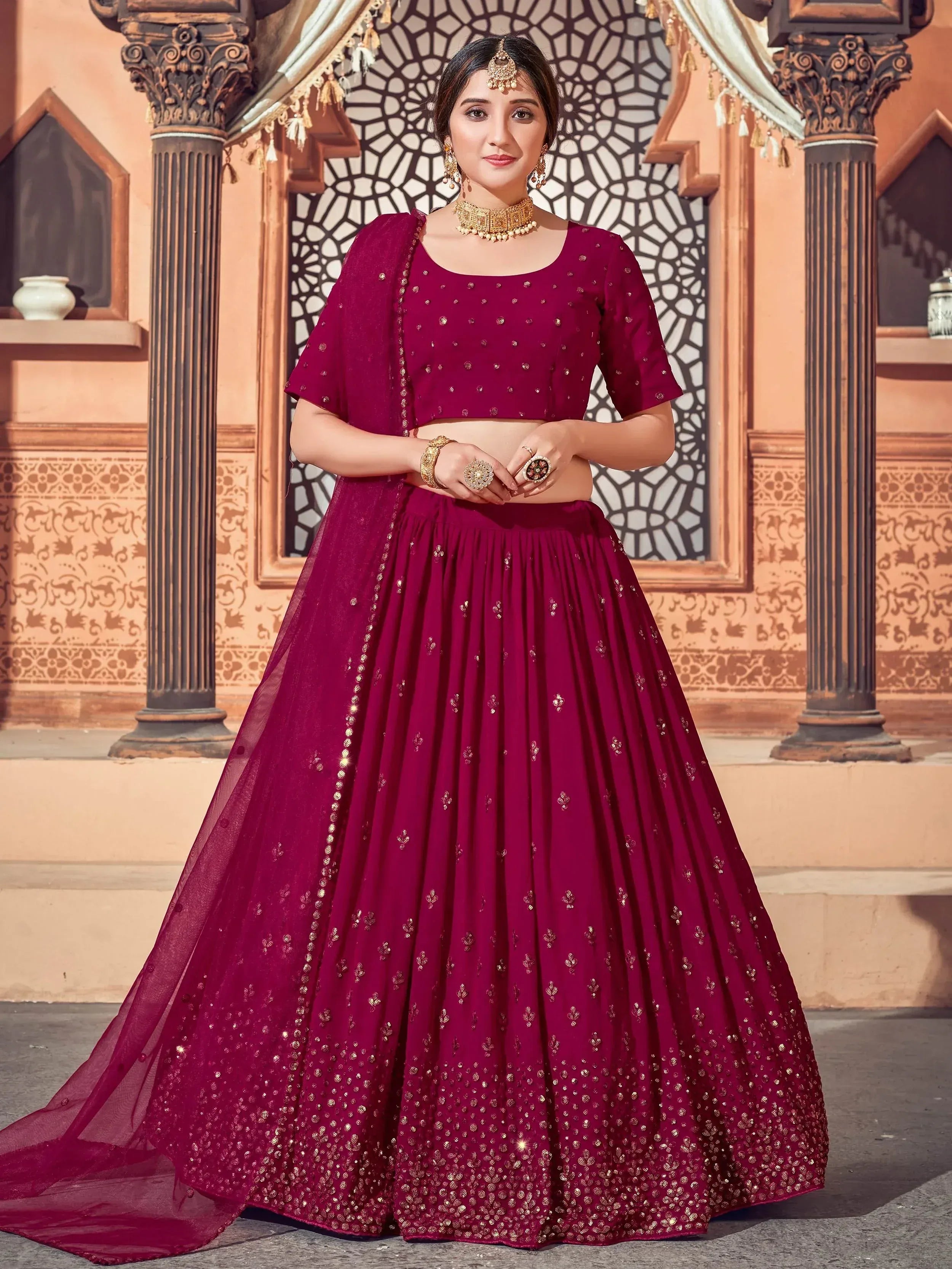 Burgundy lehenga choli with gold embroidery, perfect for Indian weddings and festive occasions