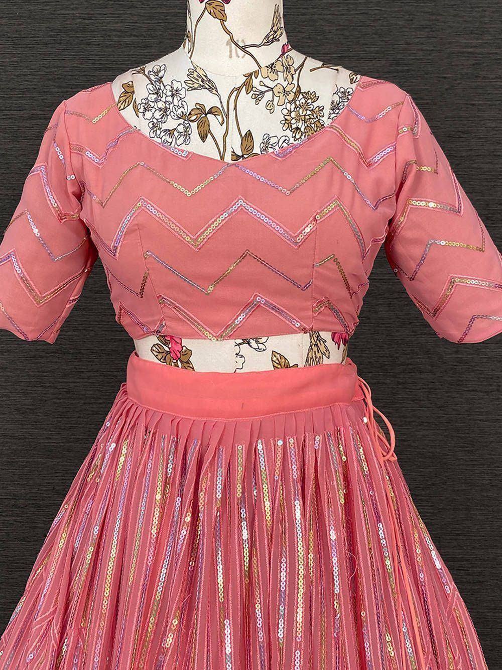 Pink ethnic lehenga choli with zigzag sequin embroidery and pleated skirt, perfect for festive occasions.