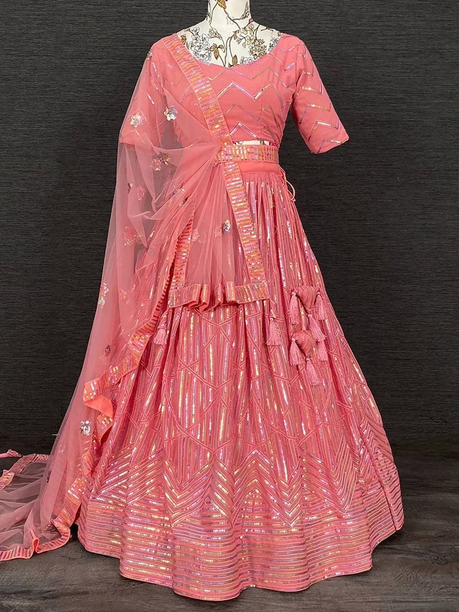 Pink designer lehenga choli with sequin chevron patterns and tassel details, perfect for ethnic occasions