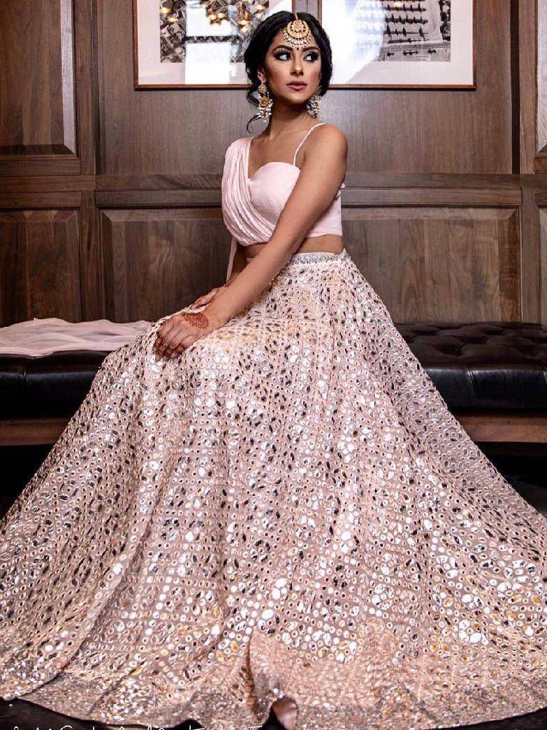 Elegant pink lehenga choli with mirror work, perfect for Indian weddings and festive occasions