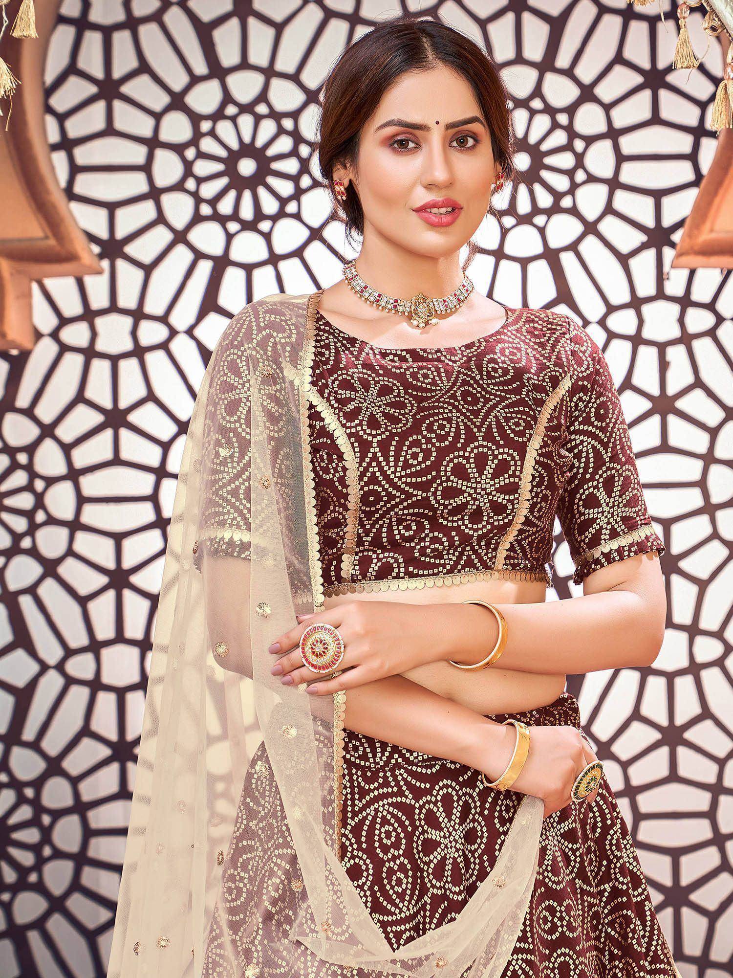 Elegant maroon lehenga choli with gold embroidery and sheer dupatta, perfect for Indian ethnic wear.