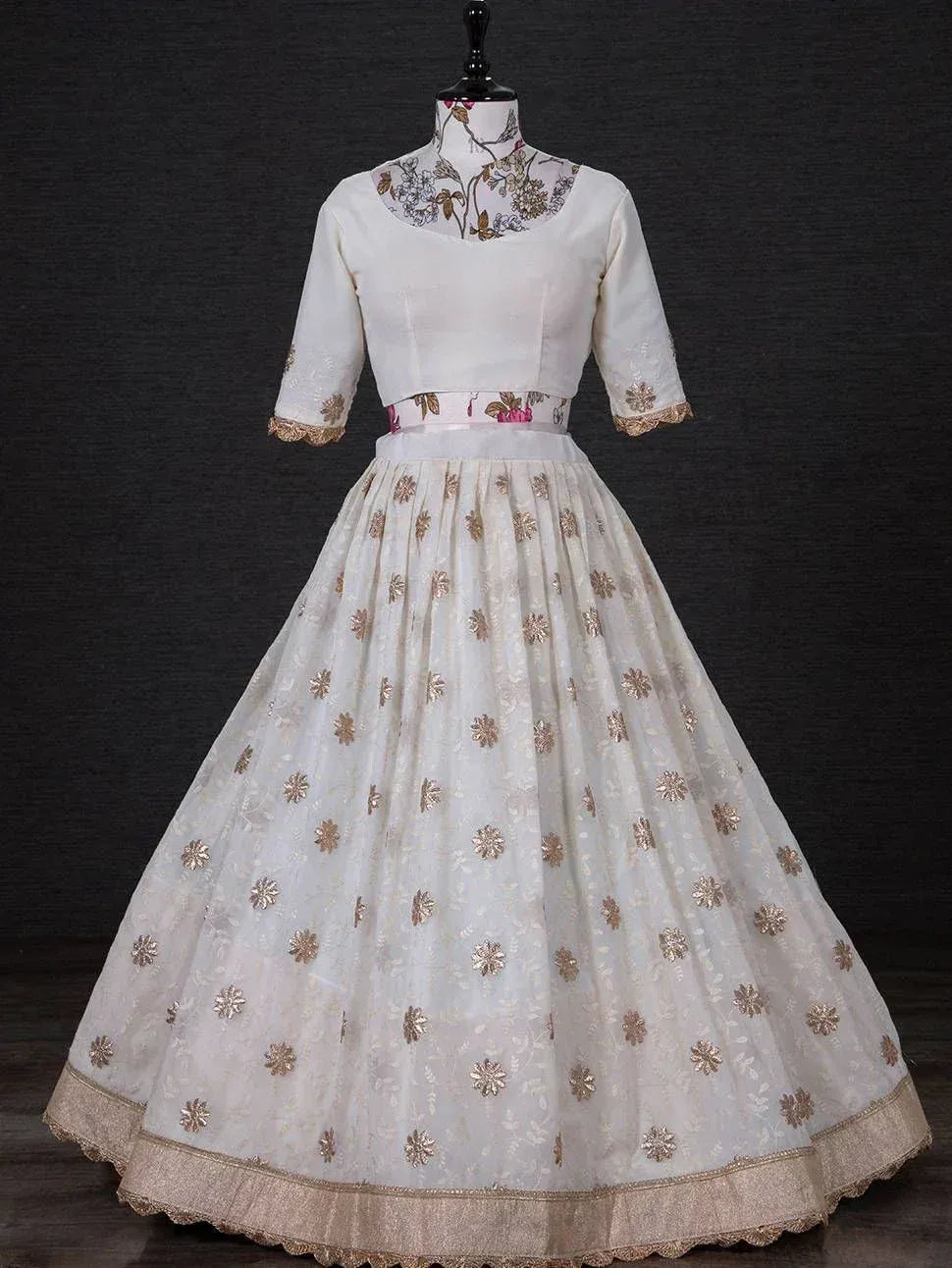 White ethnic gown with gold floral embroidery, perfect for Indian occasions and weddings