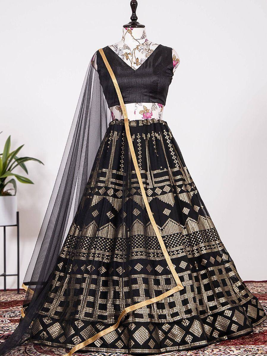 Black and gold ethnic lehenga choli with geometric print and sheer dupatta, perfect for Indian weddings and festivals.