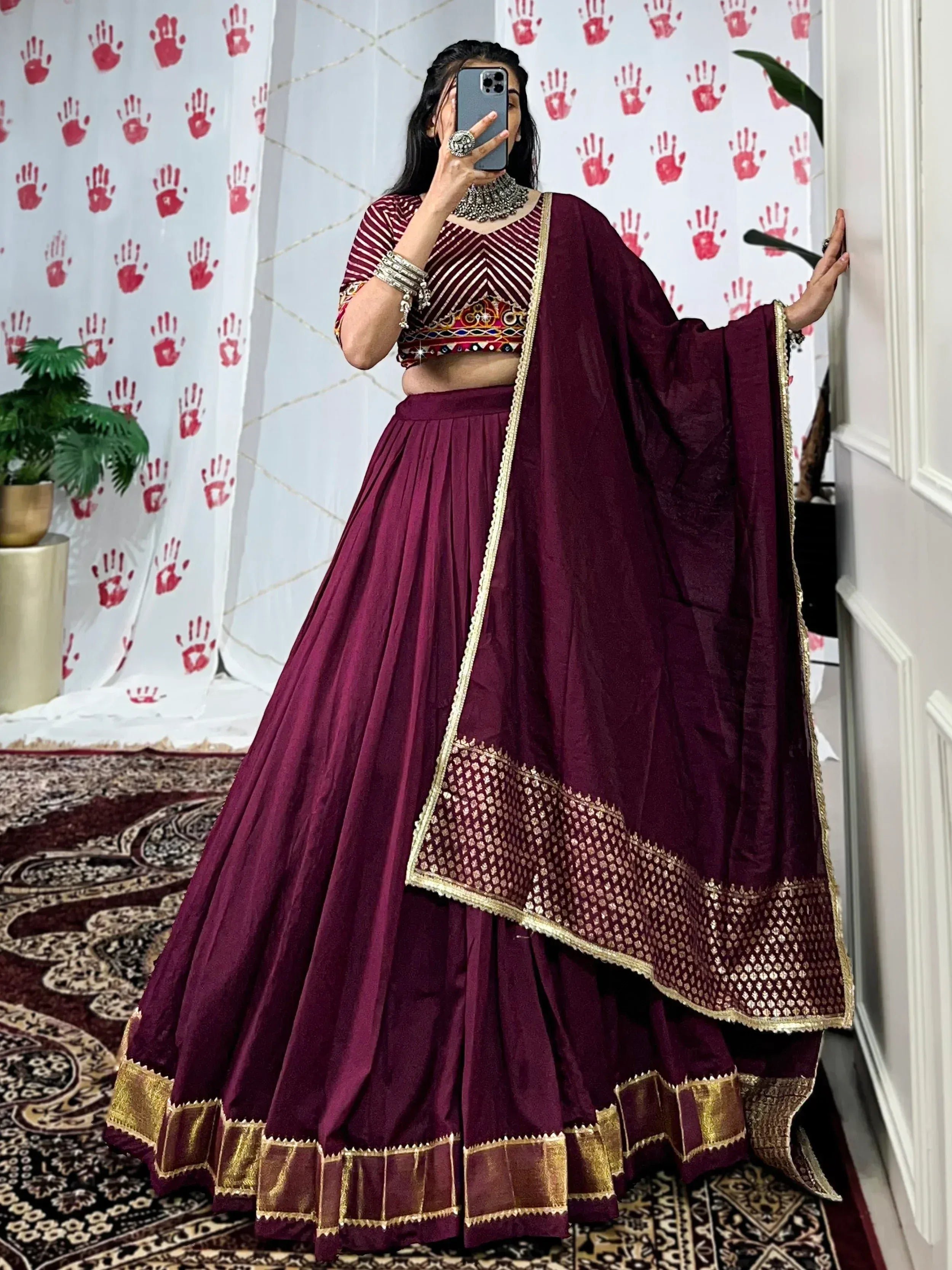 Maroon designer lehenga choli with gold embroidery, perfect for Indian ethnic wear and festive occasions.
