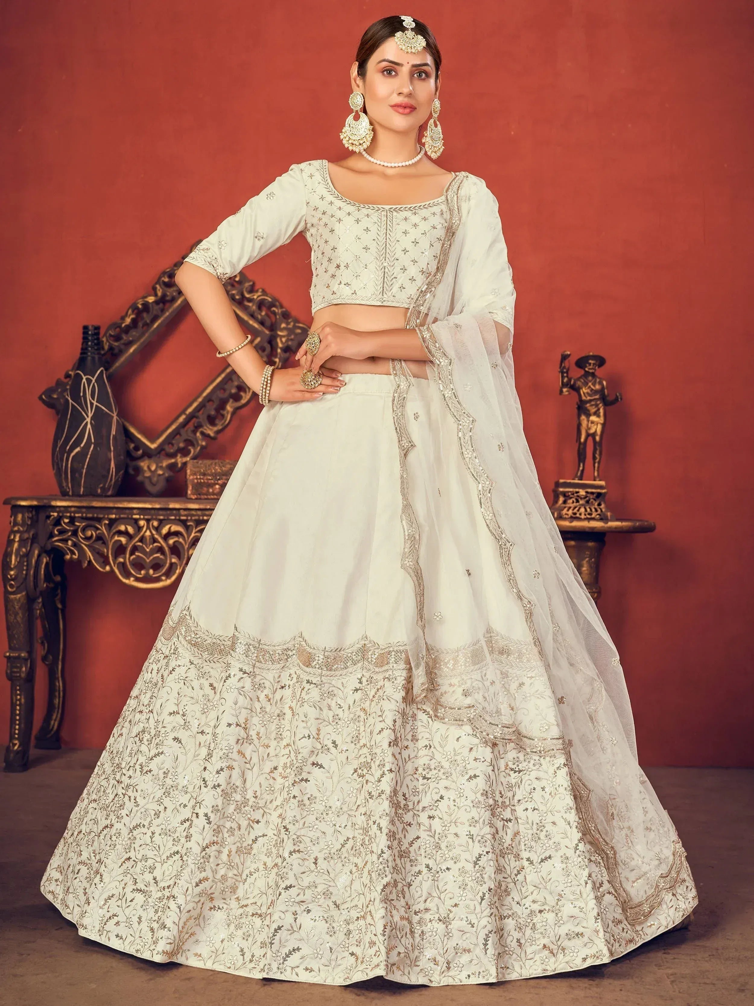 Elegant white lehenga choli with gold embroidery, perfect for Indian ethnic wear and festive occasions.