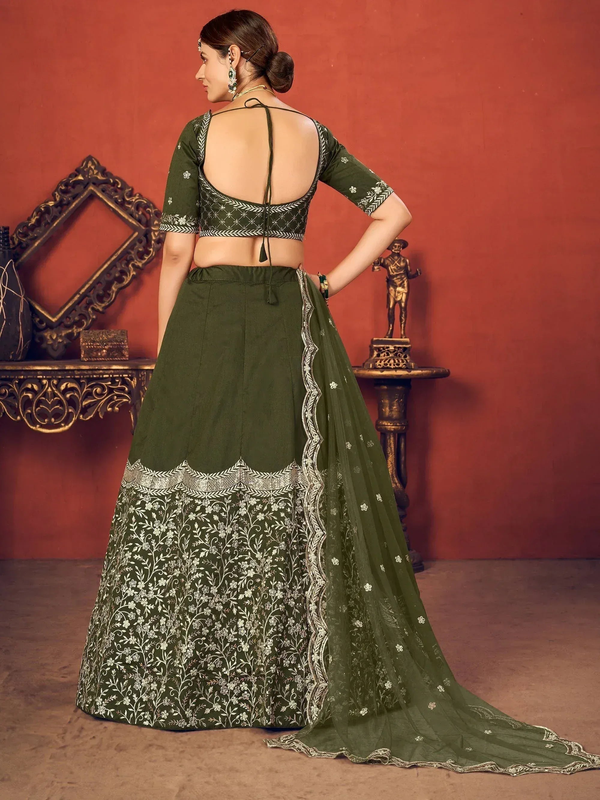 Olive green designer lehenga choli with floral embroidery and open back blouse, perfect for Indian ethnic wear.