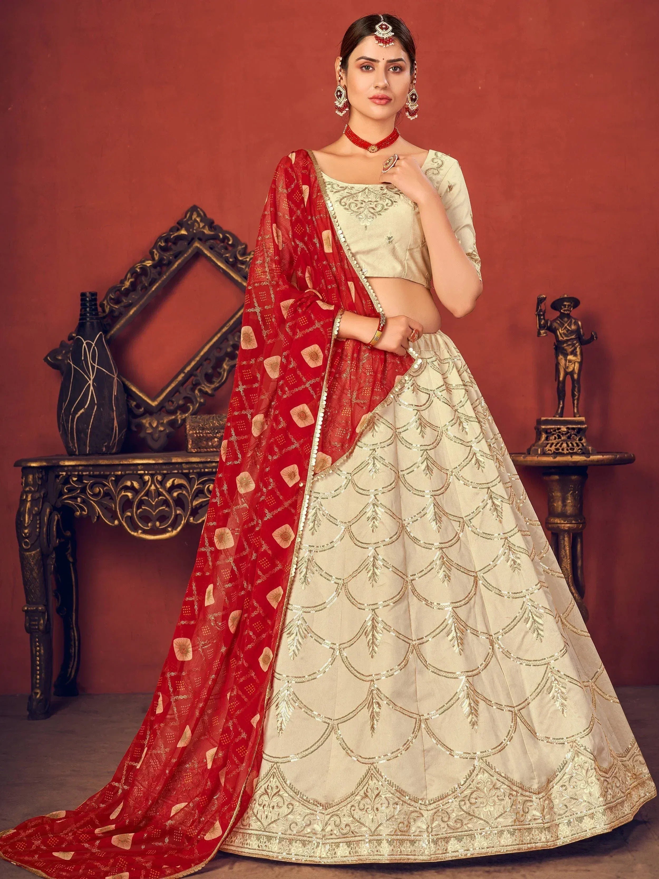 Elegant cream lehenga with gold embroidery and red dupatta, perfect for Indian ethnic wear