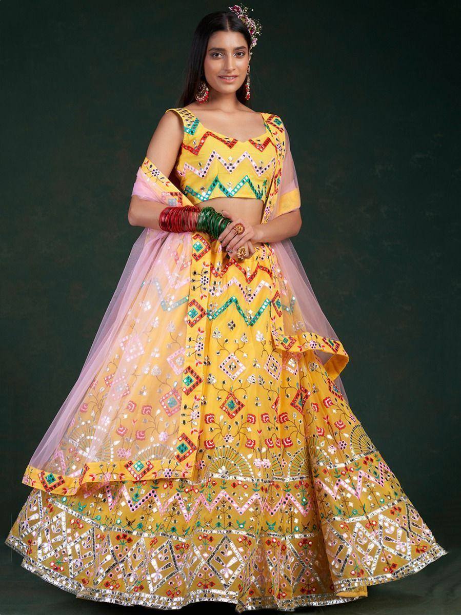 Yellow mirror-work lehenga choli with pink dupatta, ethnic Indian wedding wear