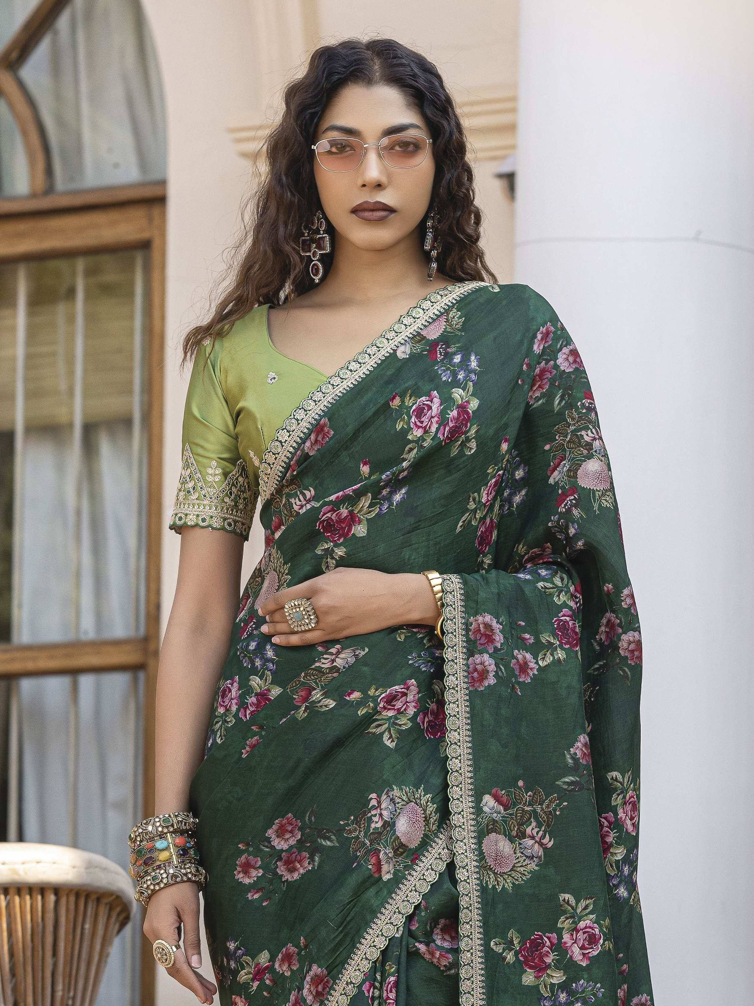 Green floral print saree with gold border and matching blouse, styled with traditional jewelry for ethnic wear.