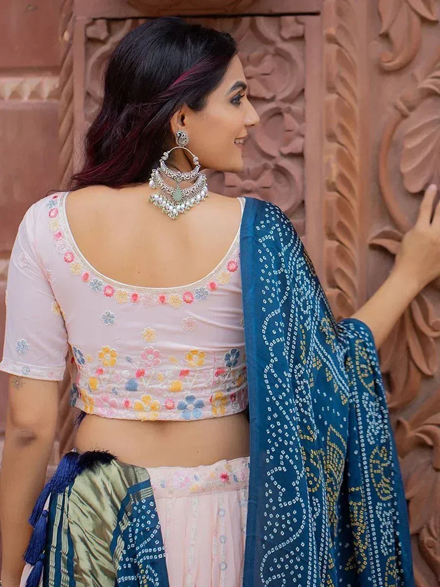 Woman in floral embroidered pink blouse with blue bandhani dupatta, Indian ethnic wear