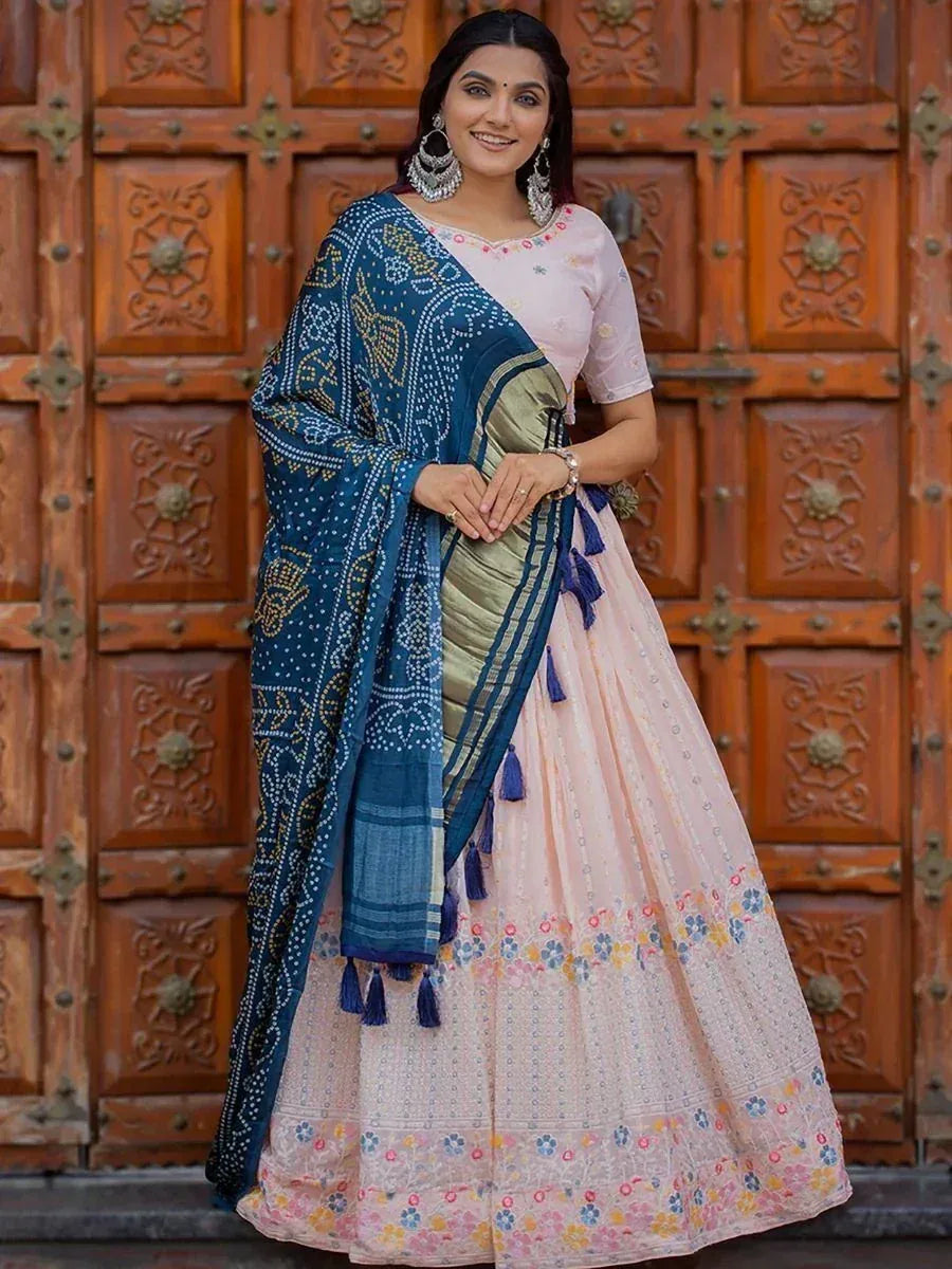 Woman in floral pink lehenga choli with blue printed dupatta, ethnic Indian wear