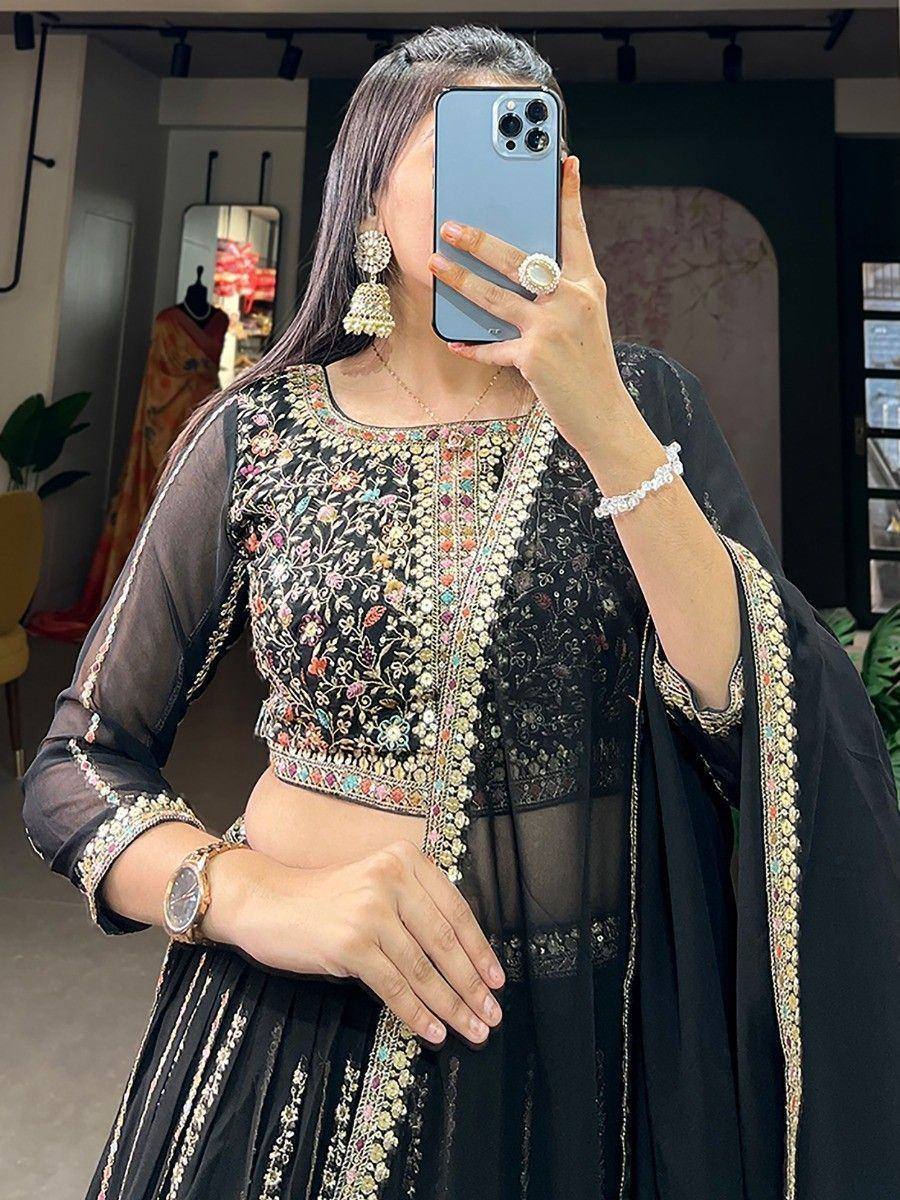 Black embroidered lehenga choli with floral motifs, sheer sleeves, and matching dupatta for ethnic wear