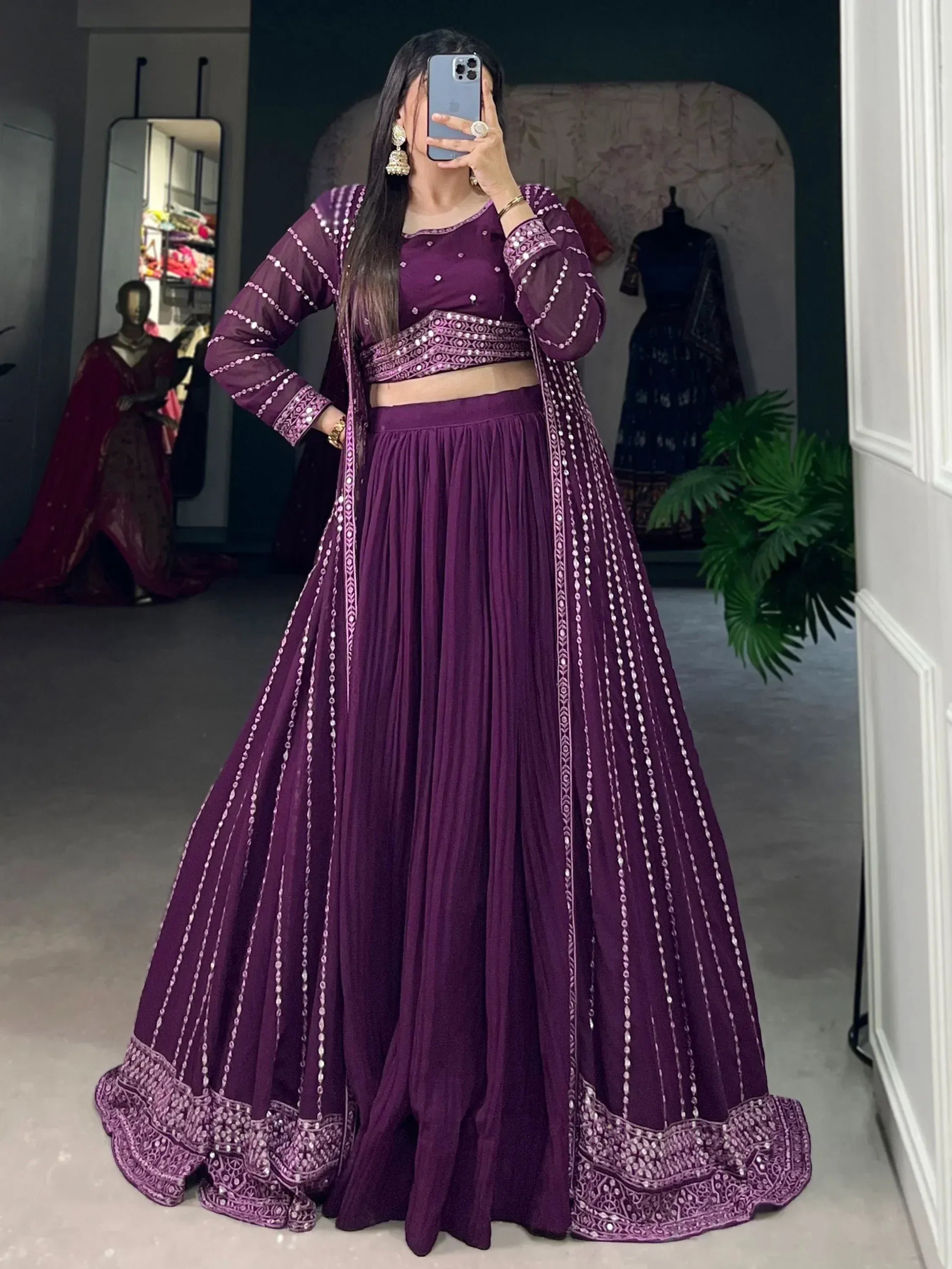 Purple Indian ethnic lehenga choli with mirror work and pleated skirt, perfect for weddings and parties