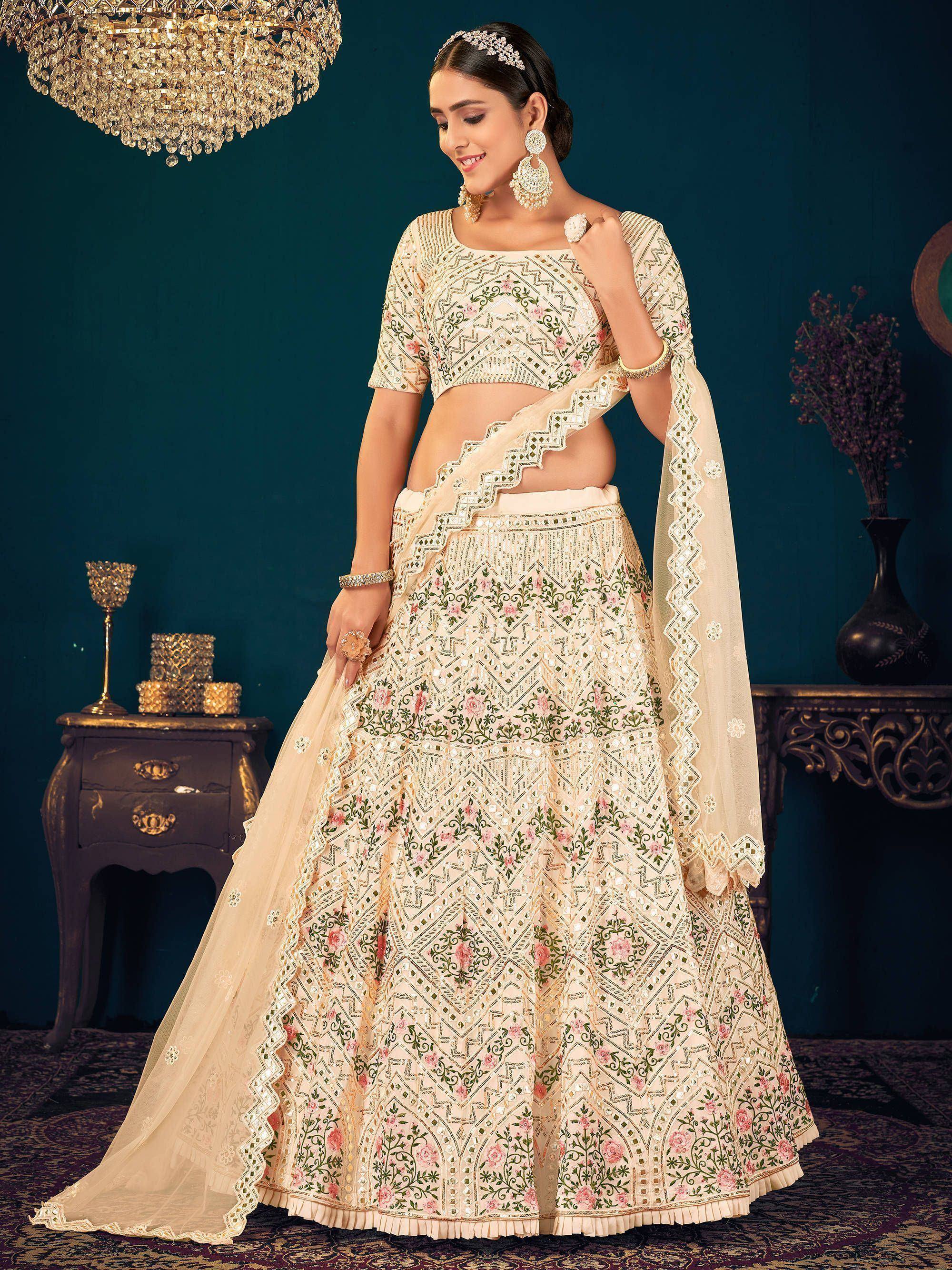 Elegant cream lehenga choli with floral embroidery and mirror work, perfect for Indian weddings and festive occasions.