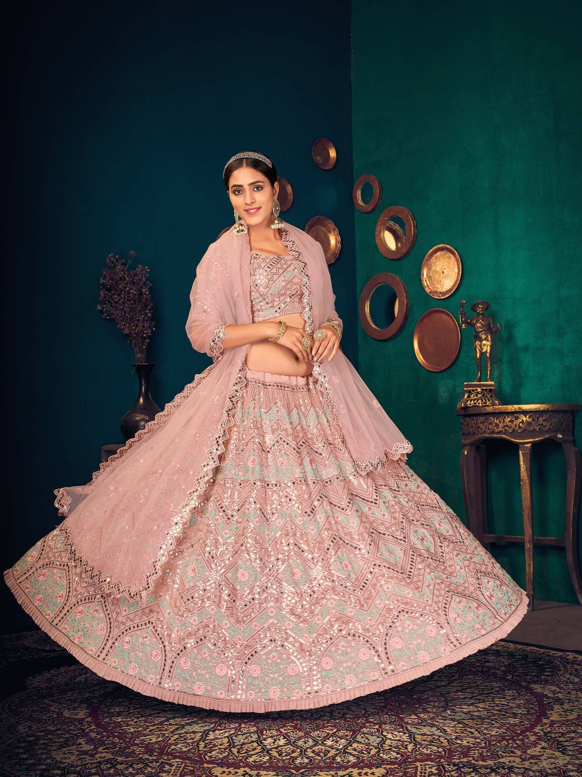 Elegant pink lehenga choli with intricate embroidery and mirror work, perfect for Indian ethnic wear.