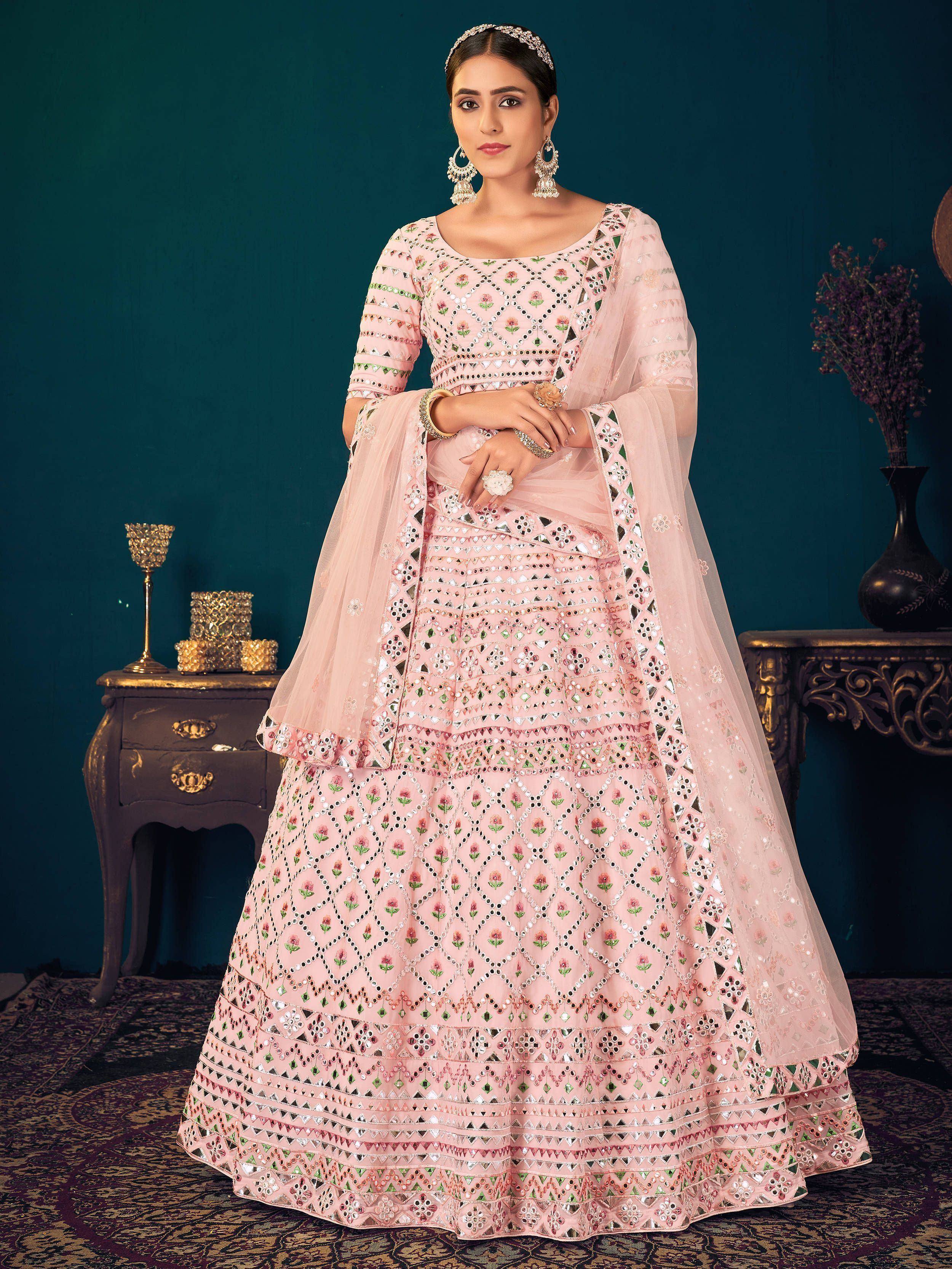 Pink embroidered lehenga choli with mirror work and floral patterns, perfect for Indian ethnic wear.