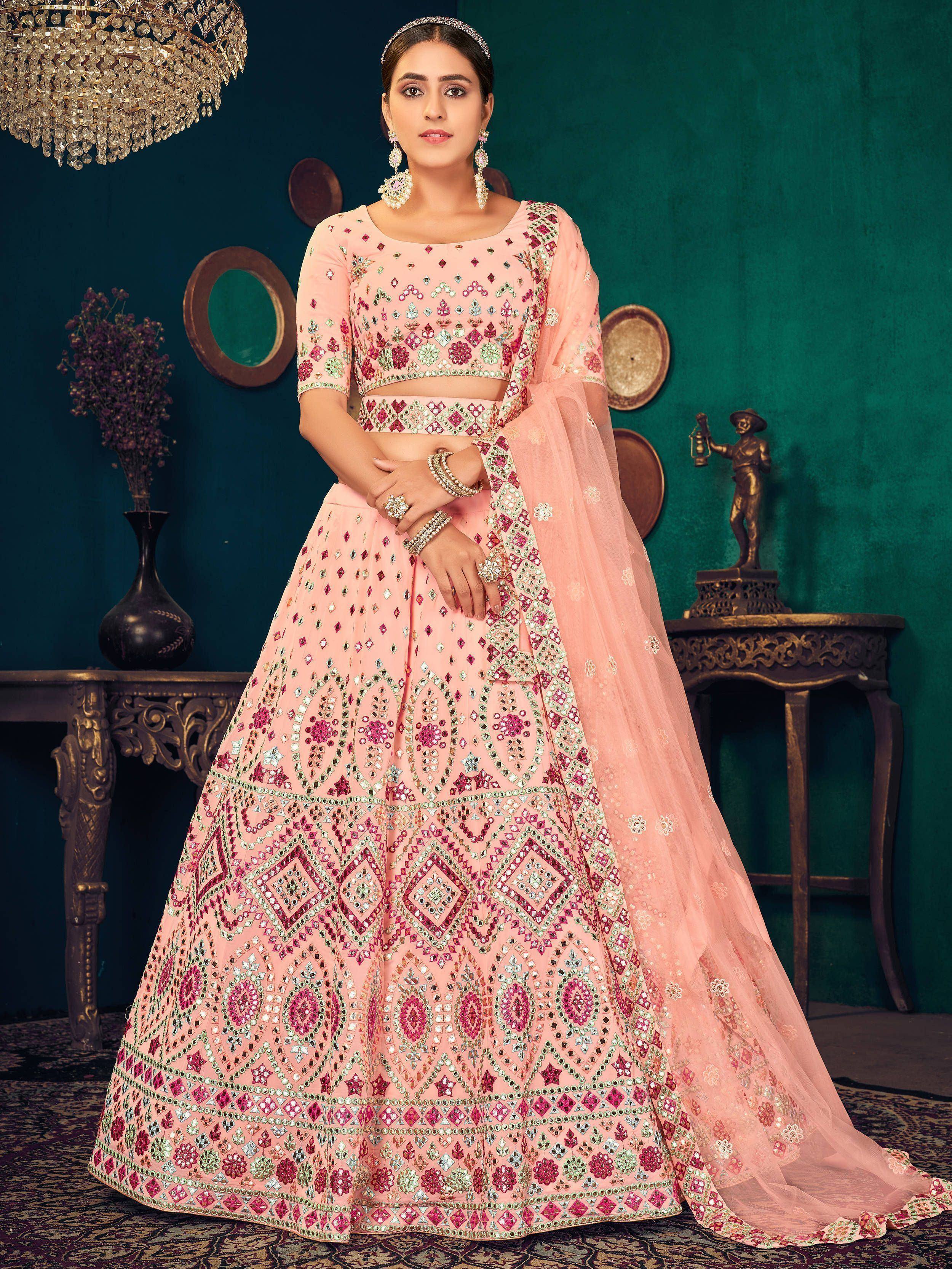 Pink designer lehenga choli with mirror work, perfect for Indian weddings and festive occasions.