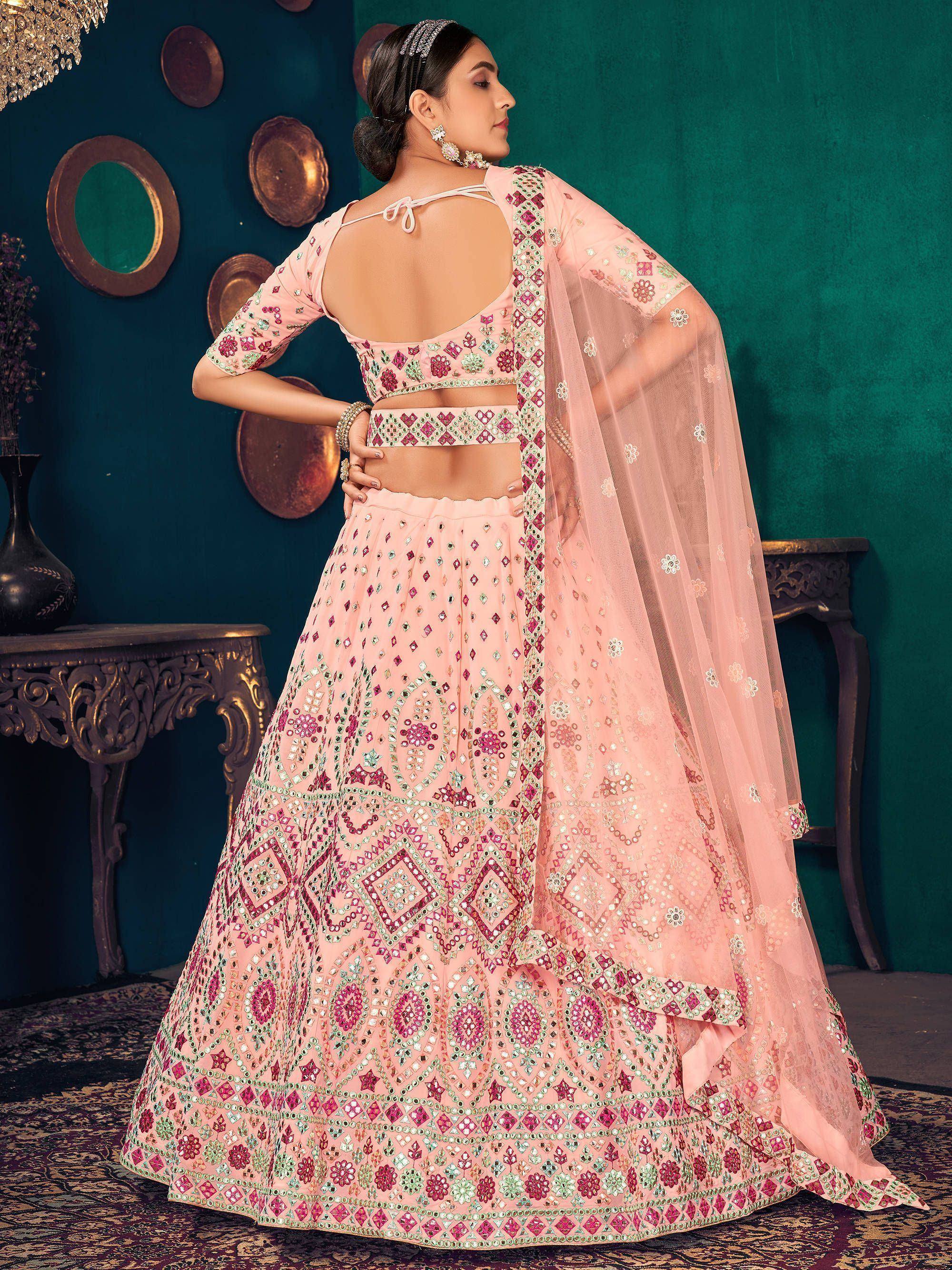 Pink embroidered lehenga choli with mirror work, perfect for Indian weddings and festive occasions.